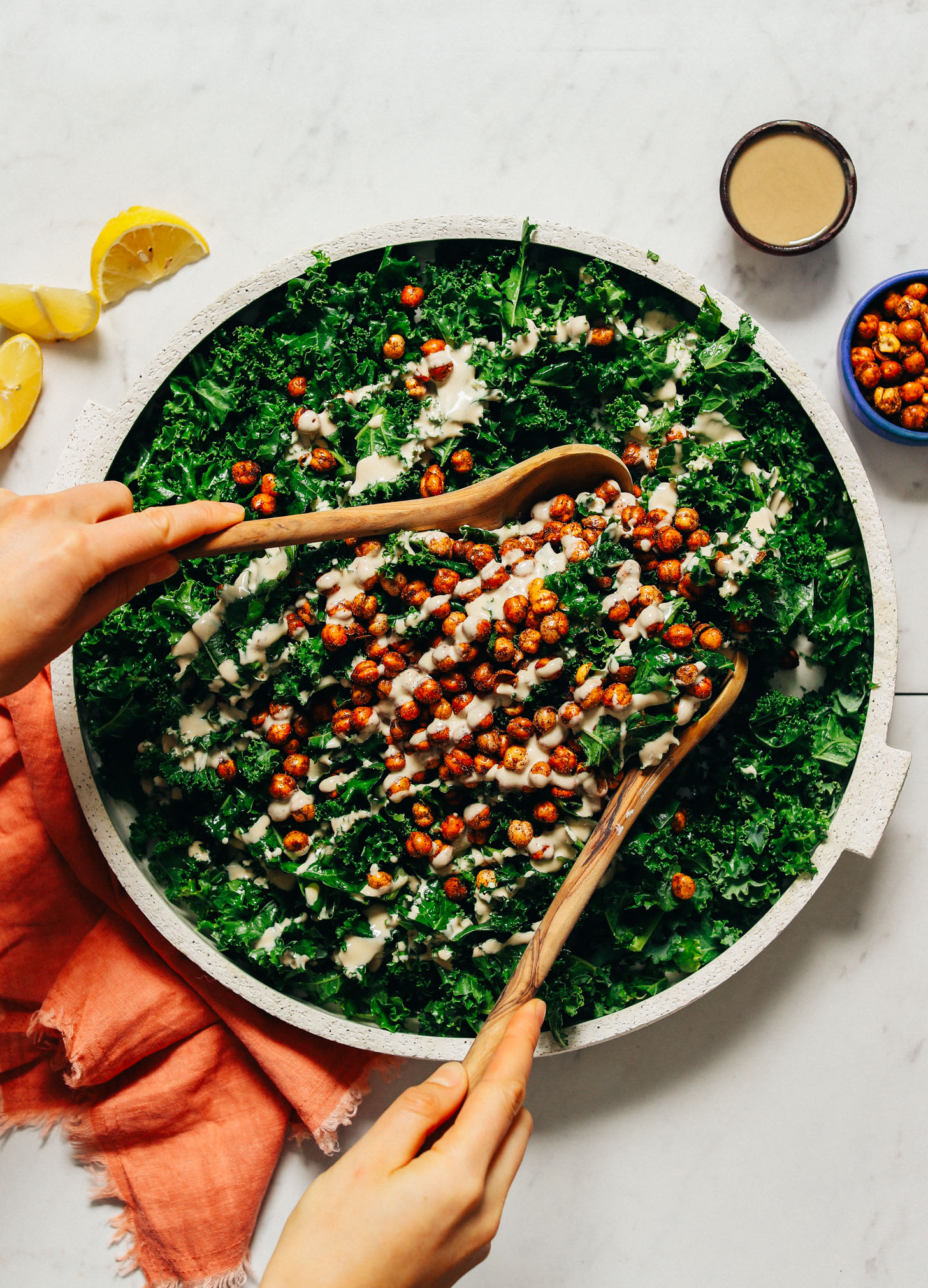 Platter of Massaged Kale Salad topped with Crispy Baked Chickpeas and tahini dressing