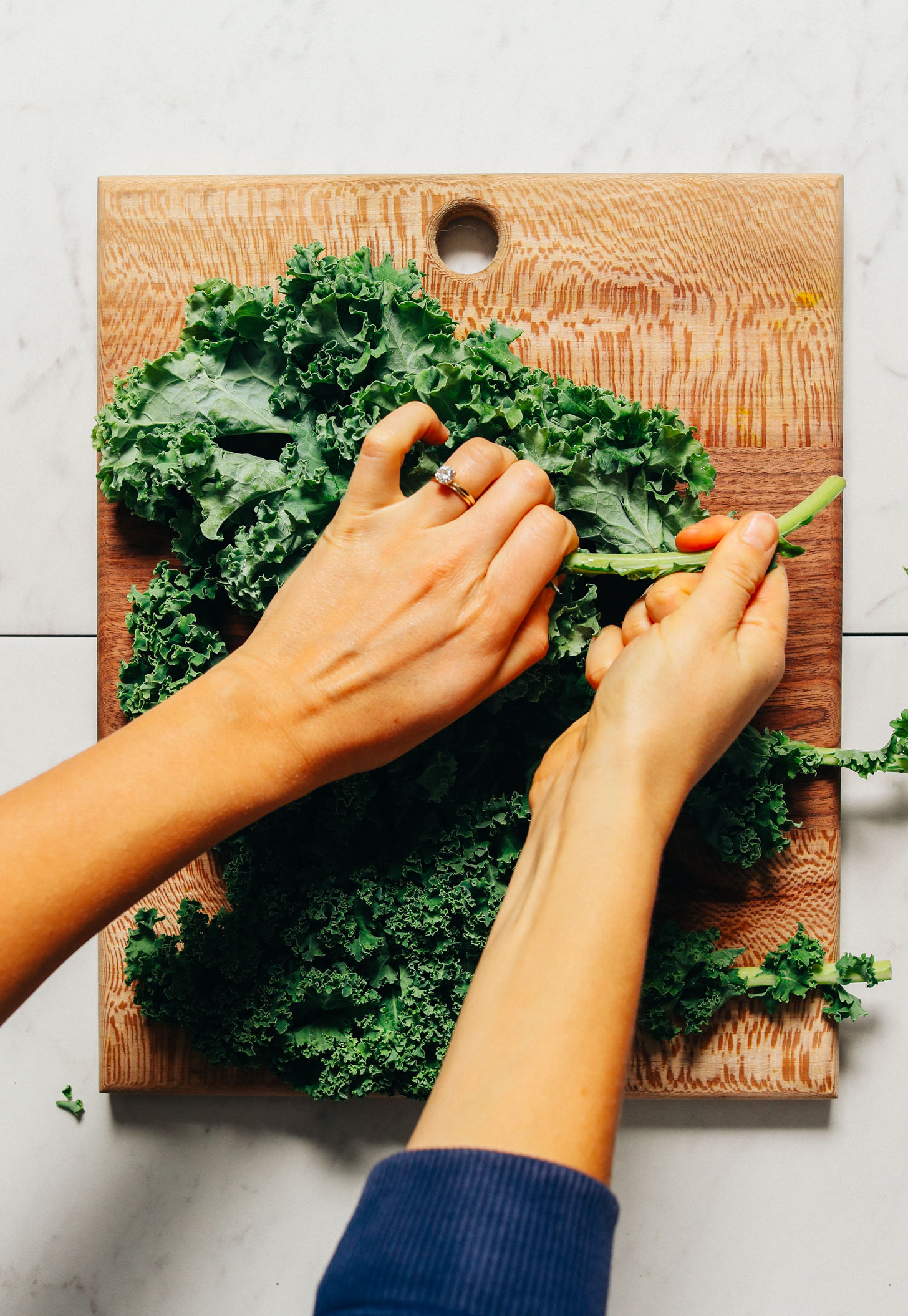 Removing the stems from kale to make our Easy Massaged Kale Salad recipe