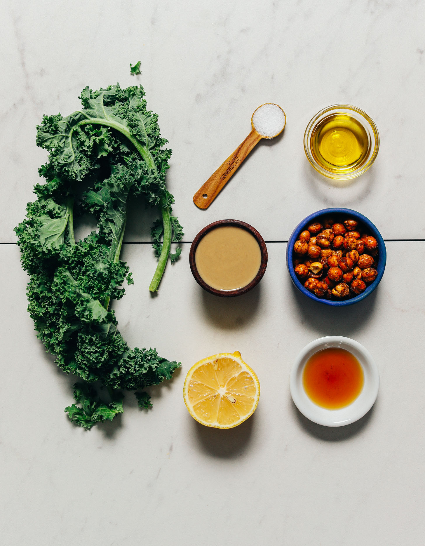 Kale, tahini, chickpeas, and other ingredients for making our Easy Massaged Kale Salad