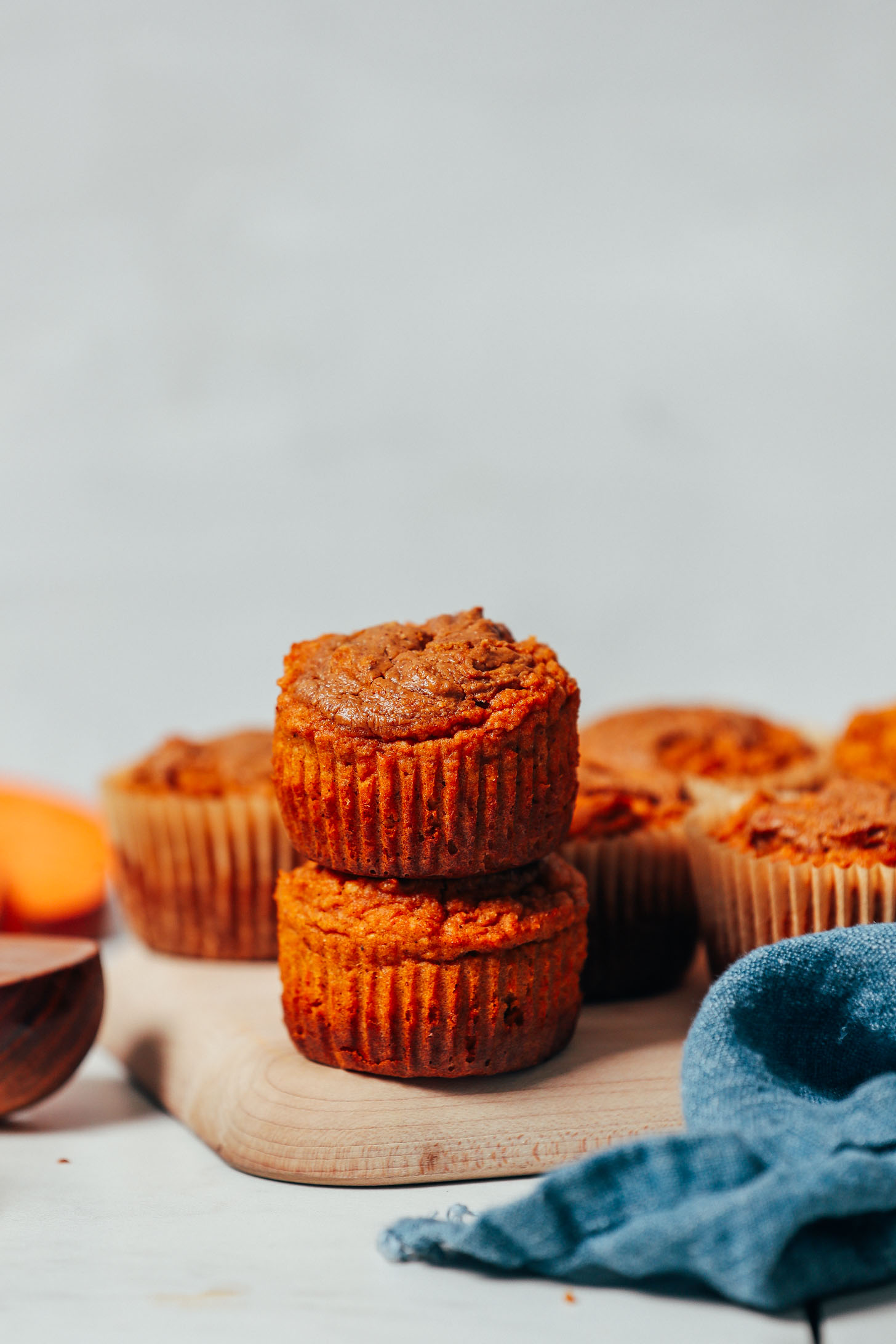 Stack of Almond Butter Sweet Potato Muffins on a cutting board