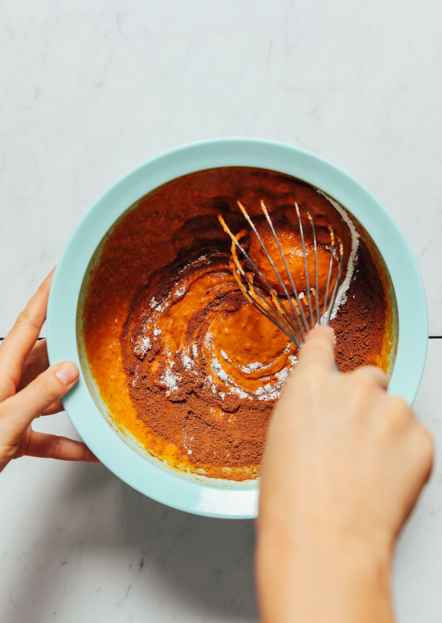 Whisking the ingredients for making our Almond Butter Sweet Potato Muffins