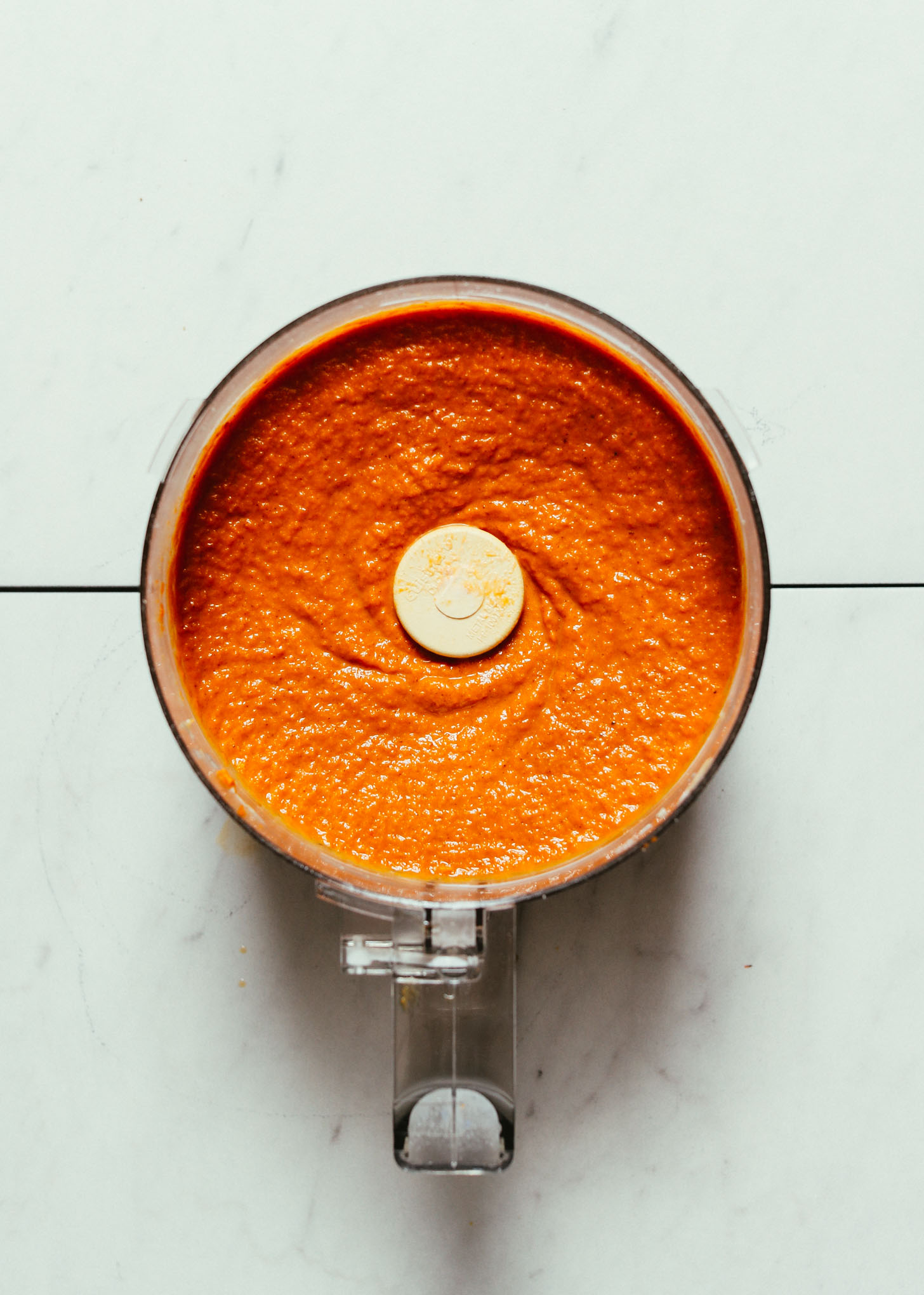 Freshly pureed pumpkin pie filling in a food processor