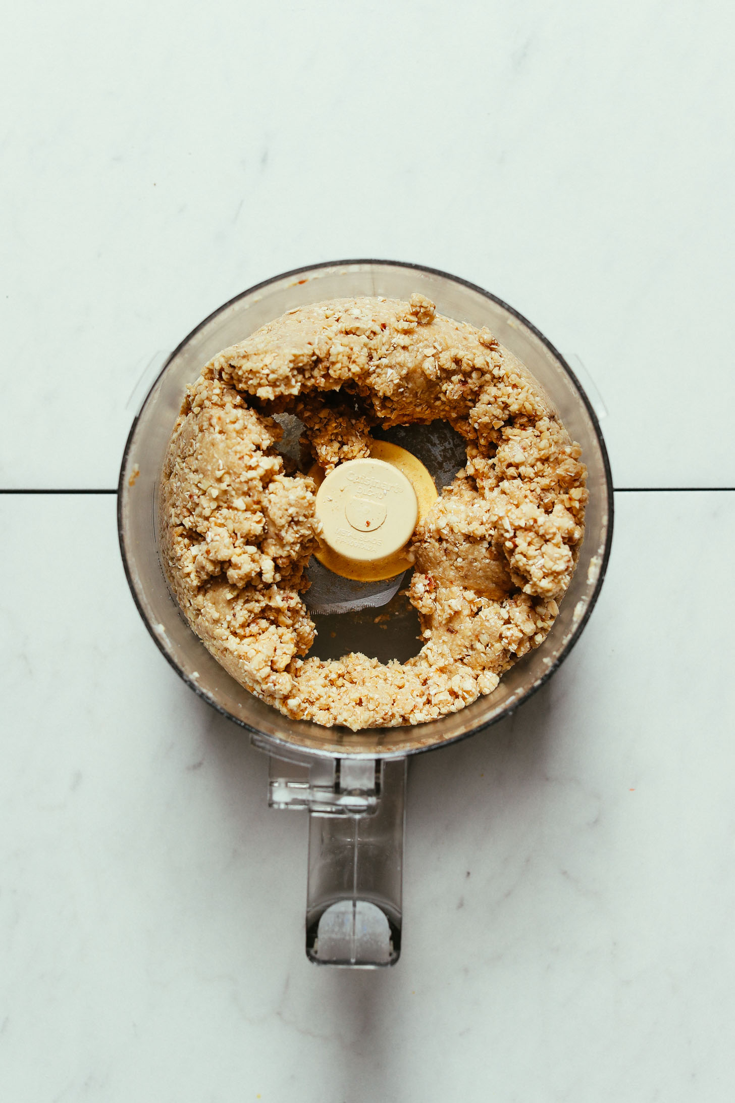Food processor with ingredients for making our Cashew Oat Crust for Pumpkin Pie