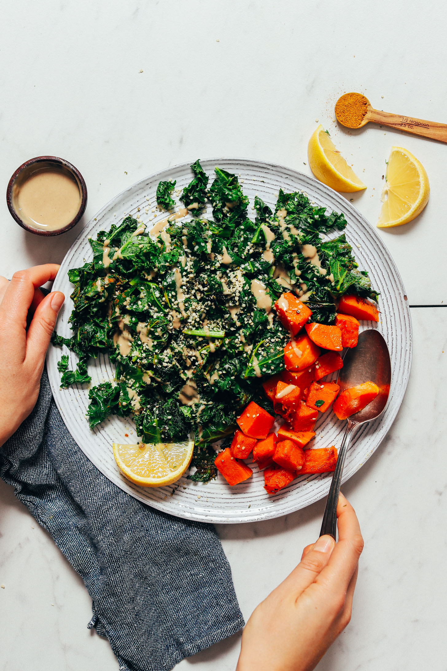 Plate of roasted sweet potatoes and sautéed kale with lemon and tahini sauce