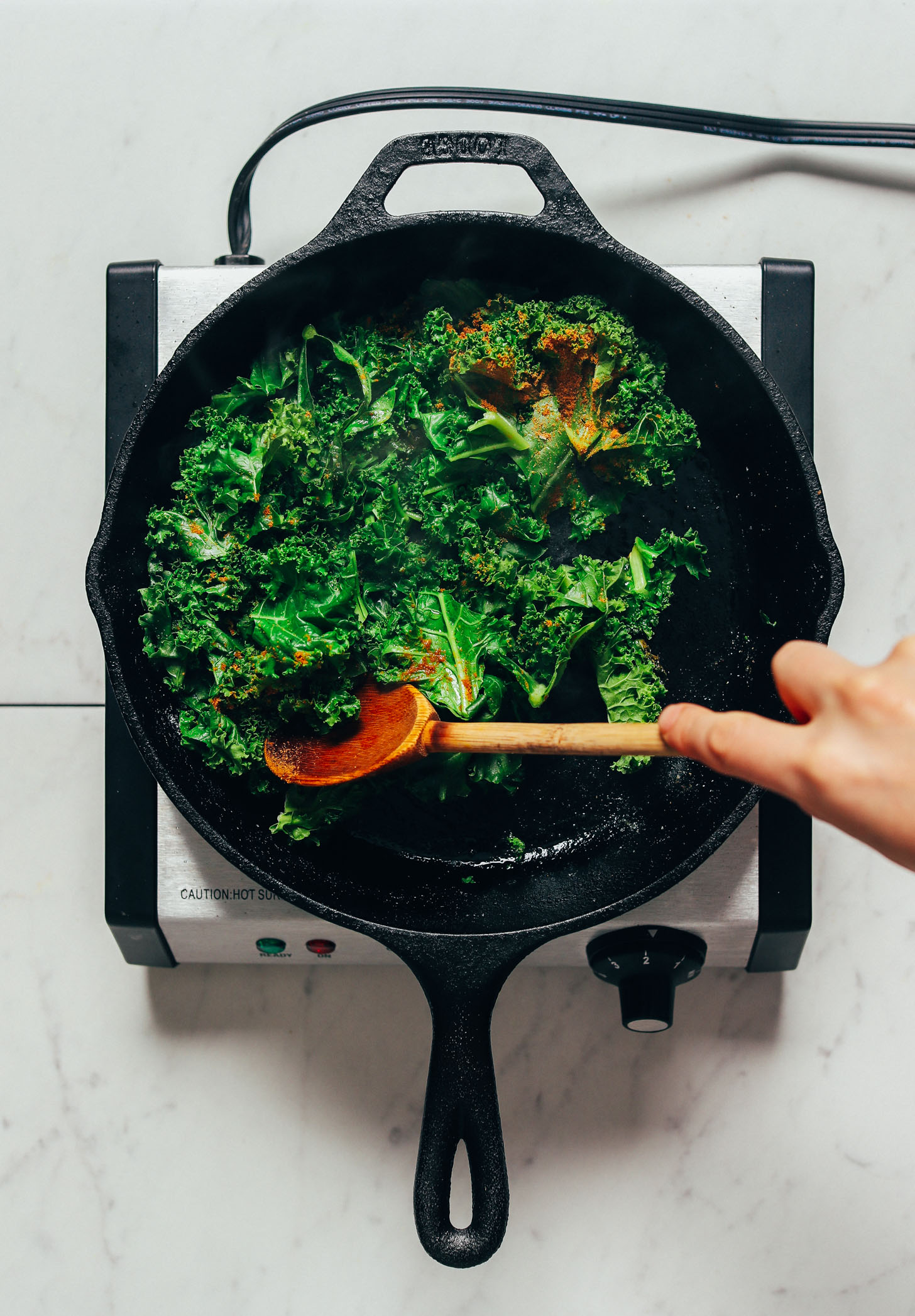 Sautéing kale in a cast iron skillet