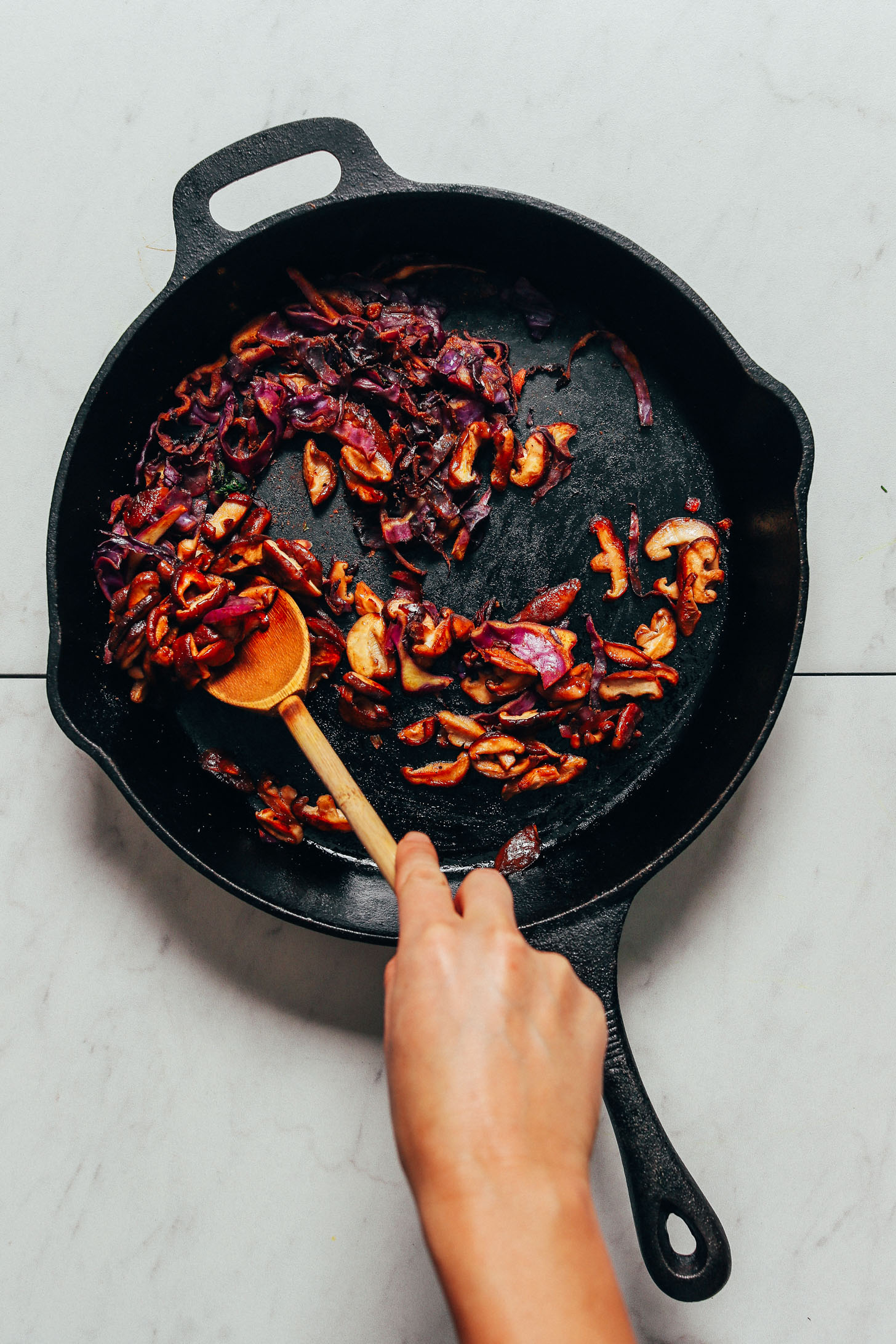 Cooking shiitake mushrooms and cabbage in a large skillet for our Simple But Good Breakfast Bowl recipe