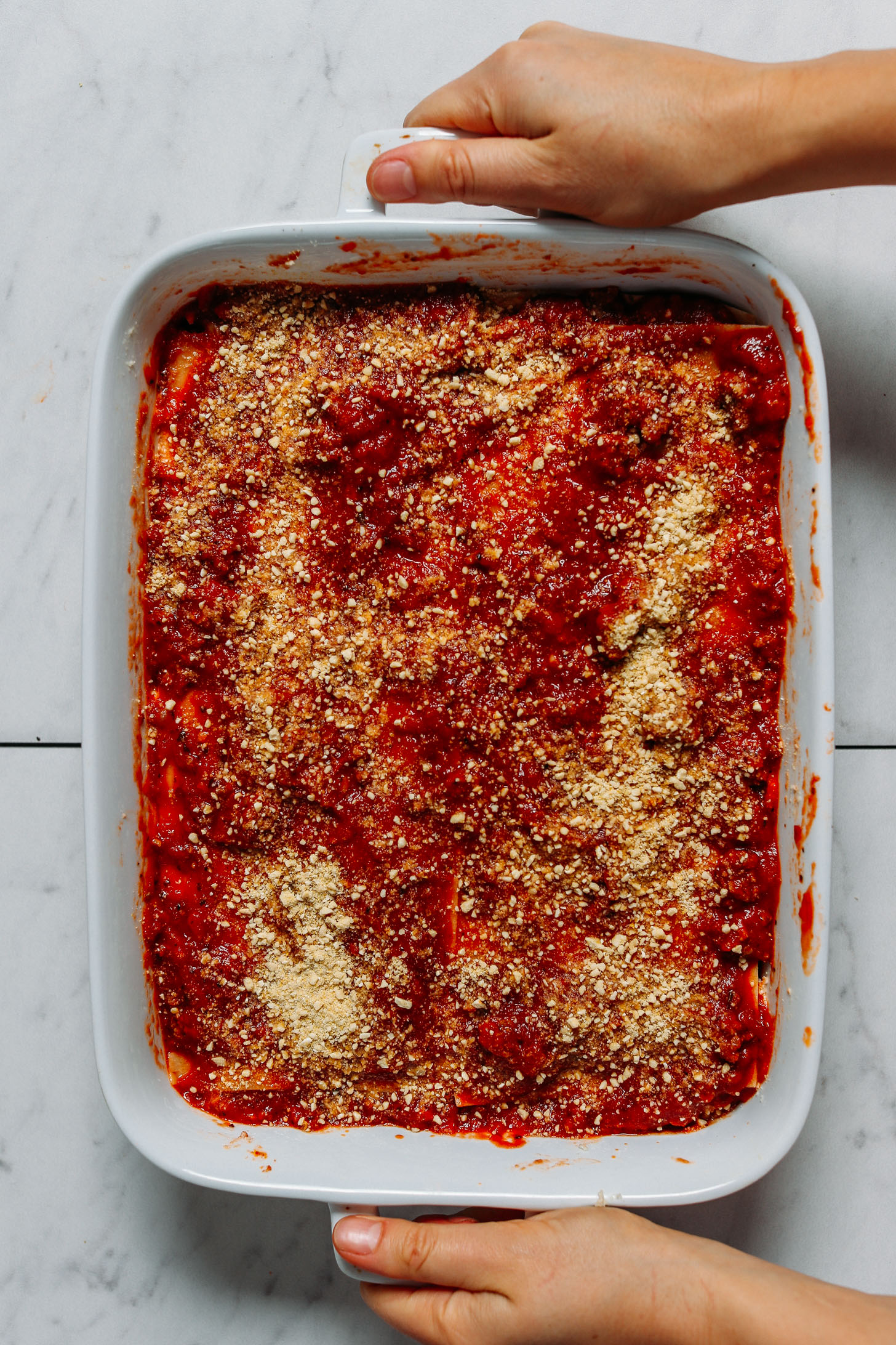 Holding the handles of a pan of our Dairy-Free Gluten-Free Lasagna recipe