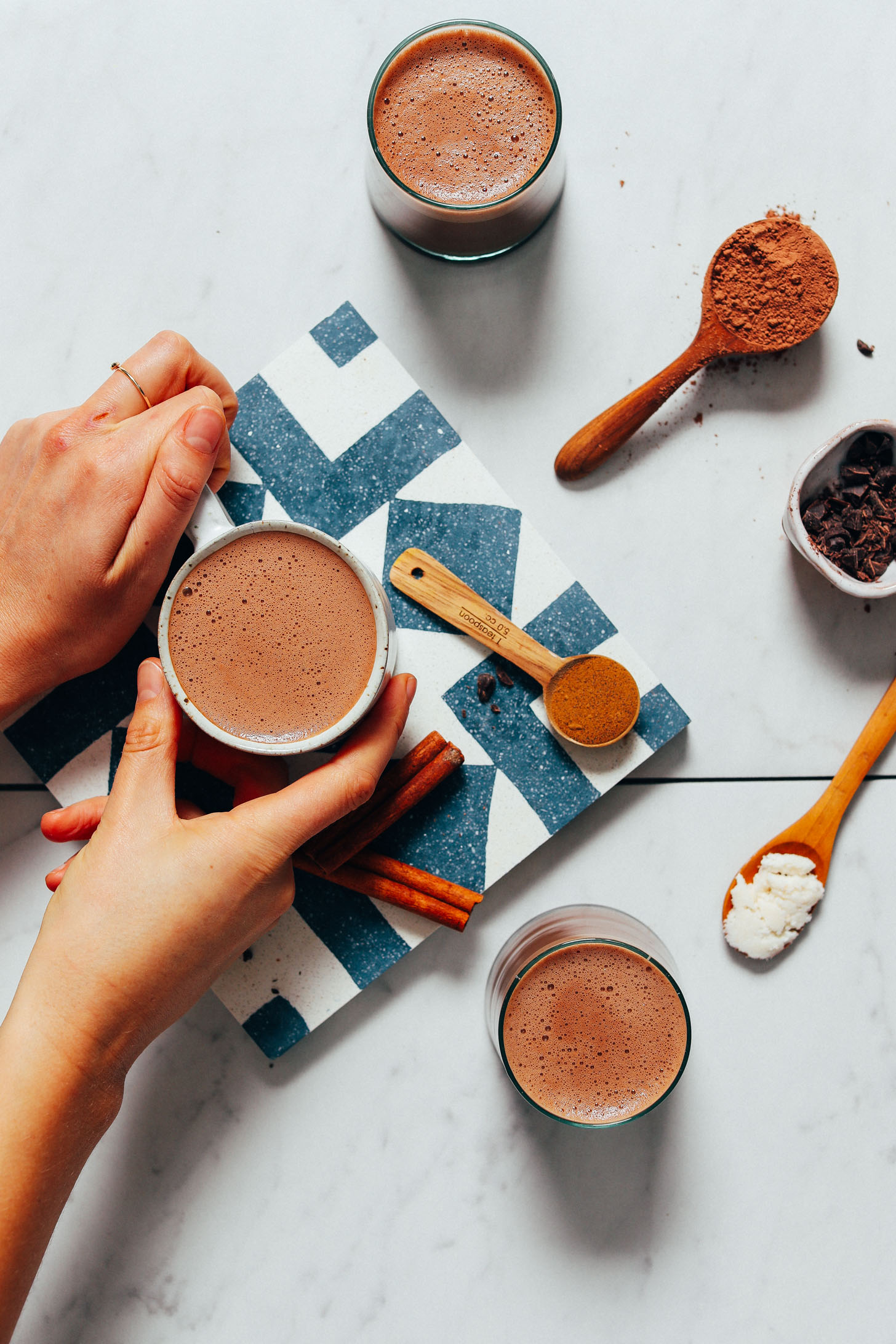 Holding a mug of Adaptogenic Hot Chocolate made from our mix recipe