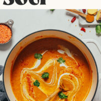 Wooden spoon resting in a pot of our easy 1-pot curried cauliflower lentil soup