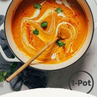 Wooden spoon resting in a pot of Curried Cauliflower Soup