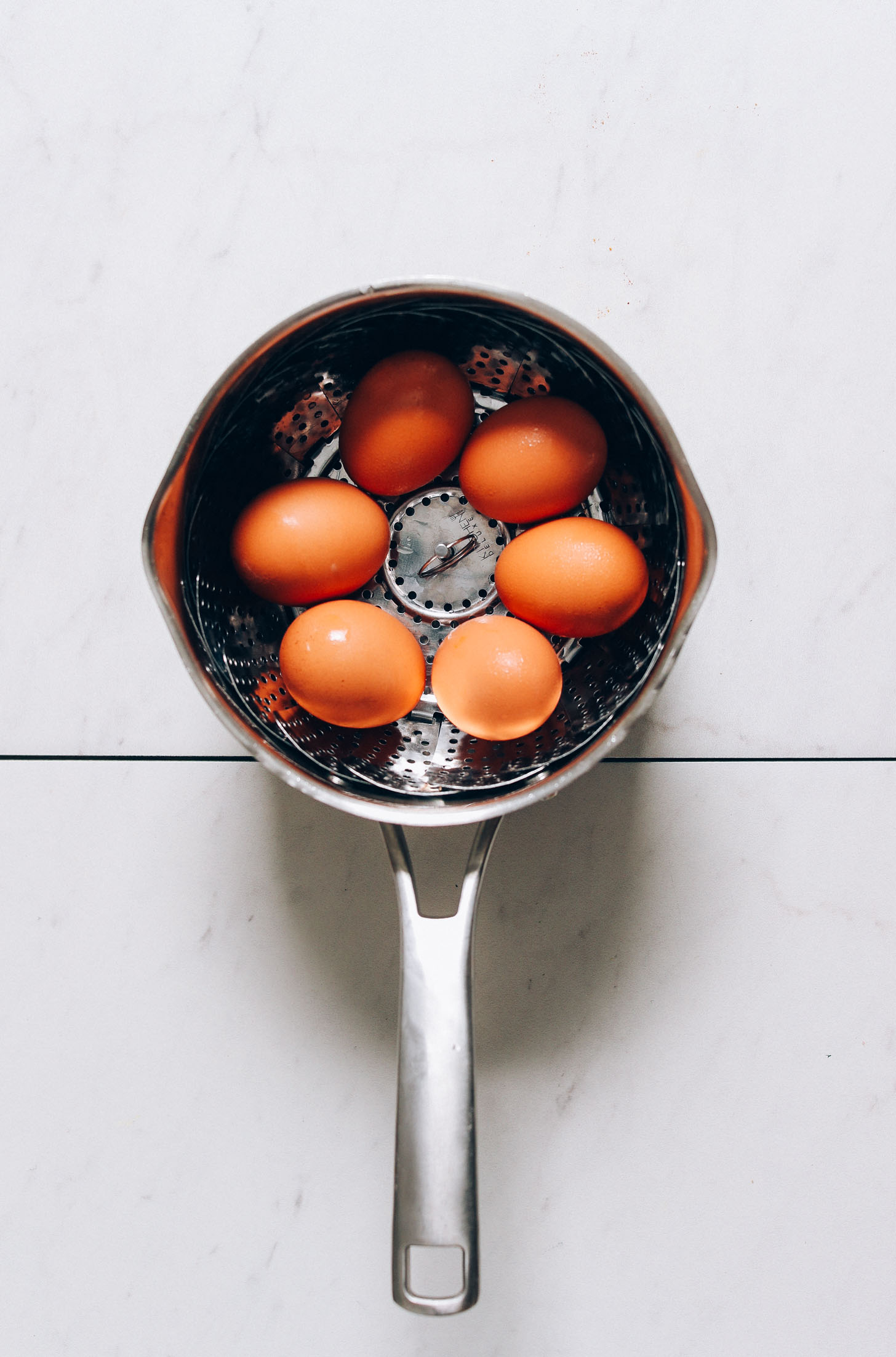 Making hard-boiled eggs in a steamer basket for our Deviled Eggs recipe