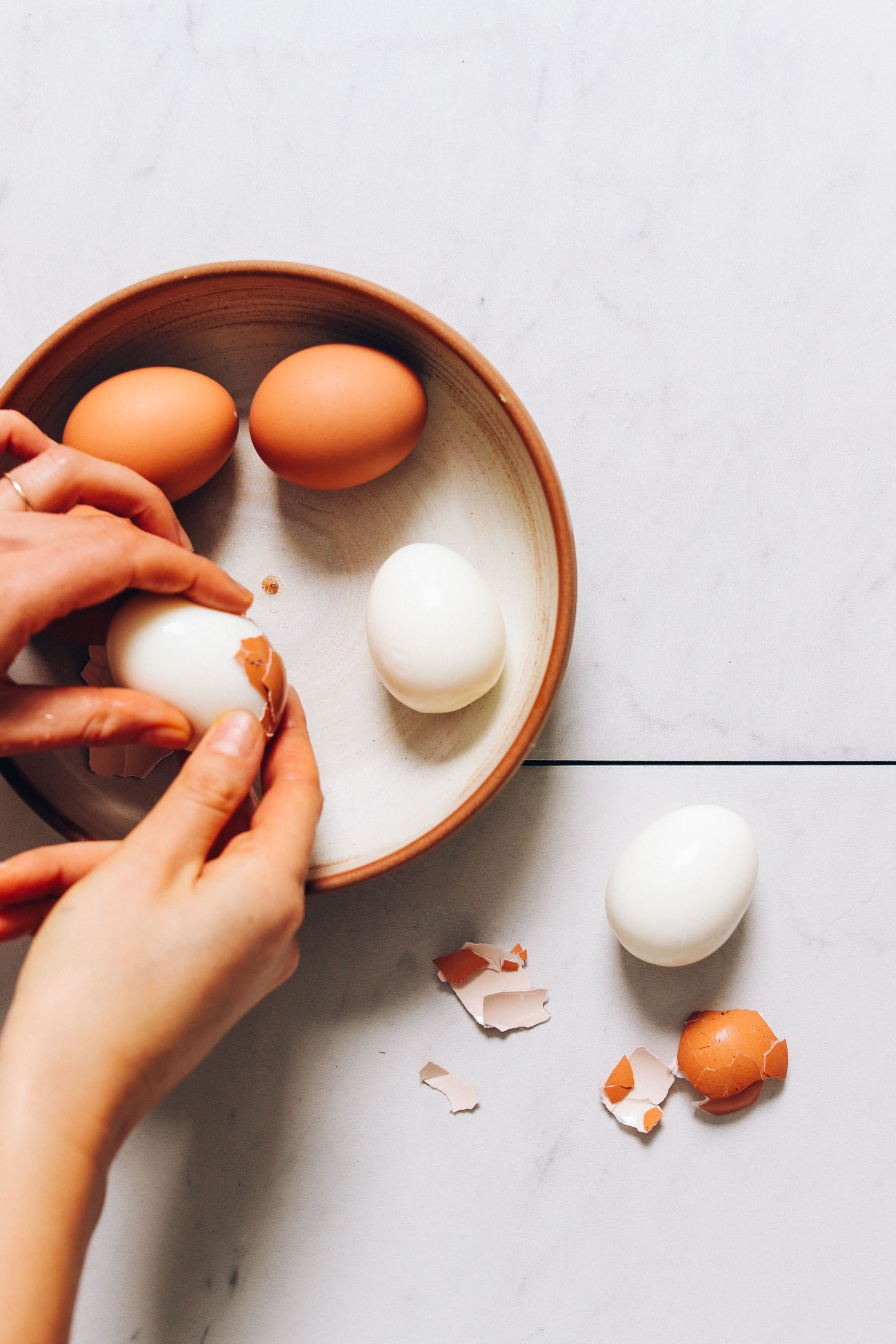 Peeling hard boiled eggs for our Deviled Eggs recipe