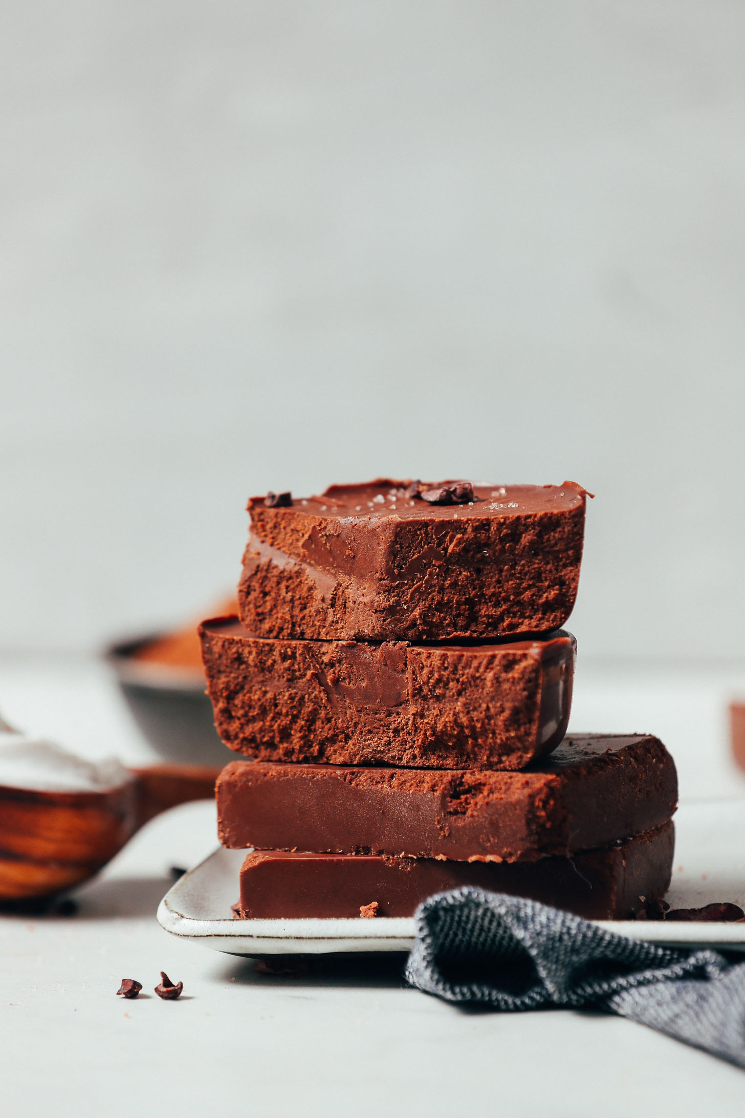 Stack of Vegan Milk Chocolate Bars topped with sea salt and cacao nibs