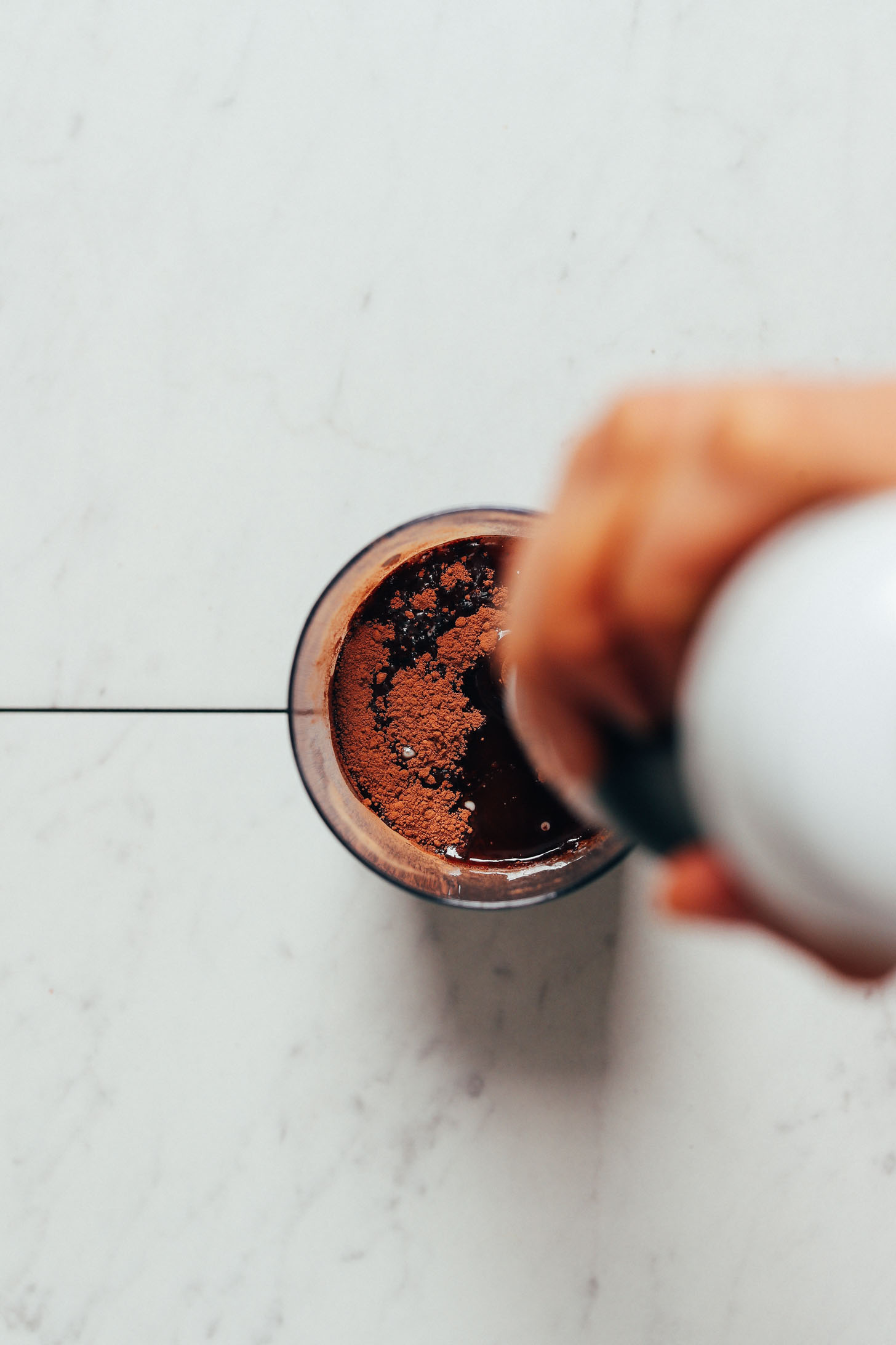 Using an immersion blender to blend our Easy Vegan Milk Chocolate recipe