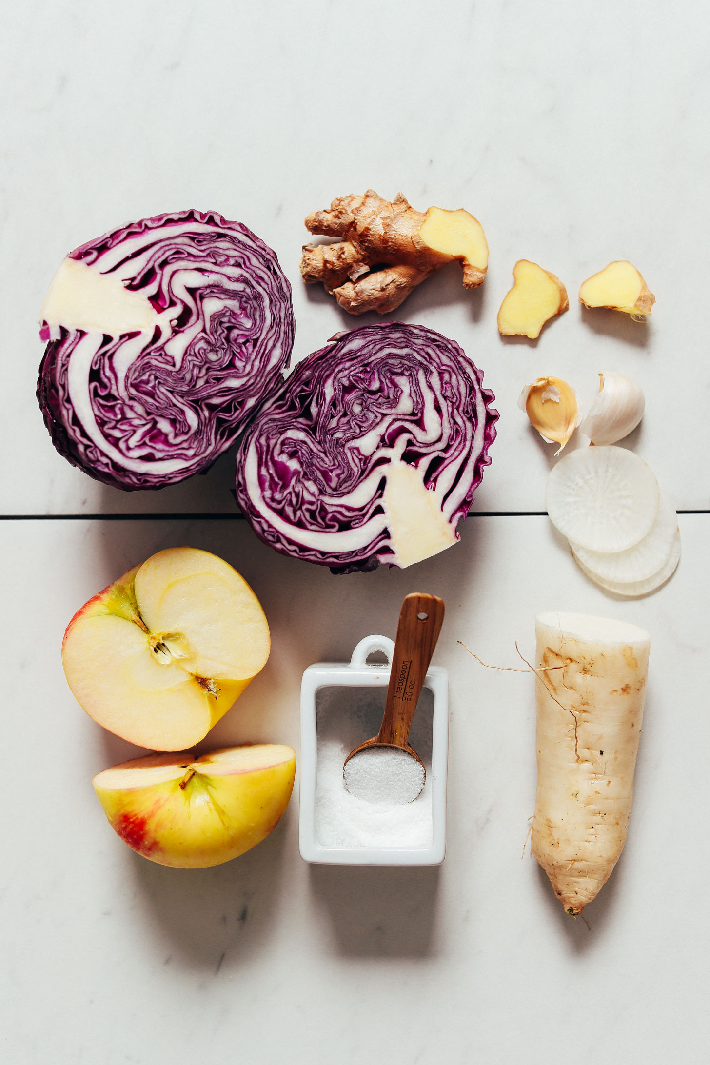 Daikon, red cabbage, apple, salt, ginger, and garlic for making our Apple-Cabbage Sauerkraut recipe