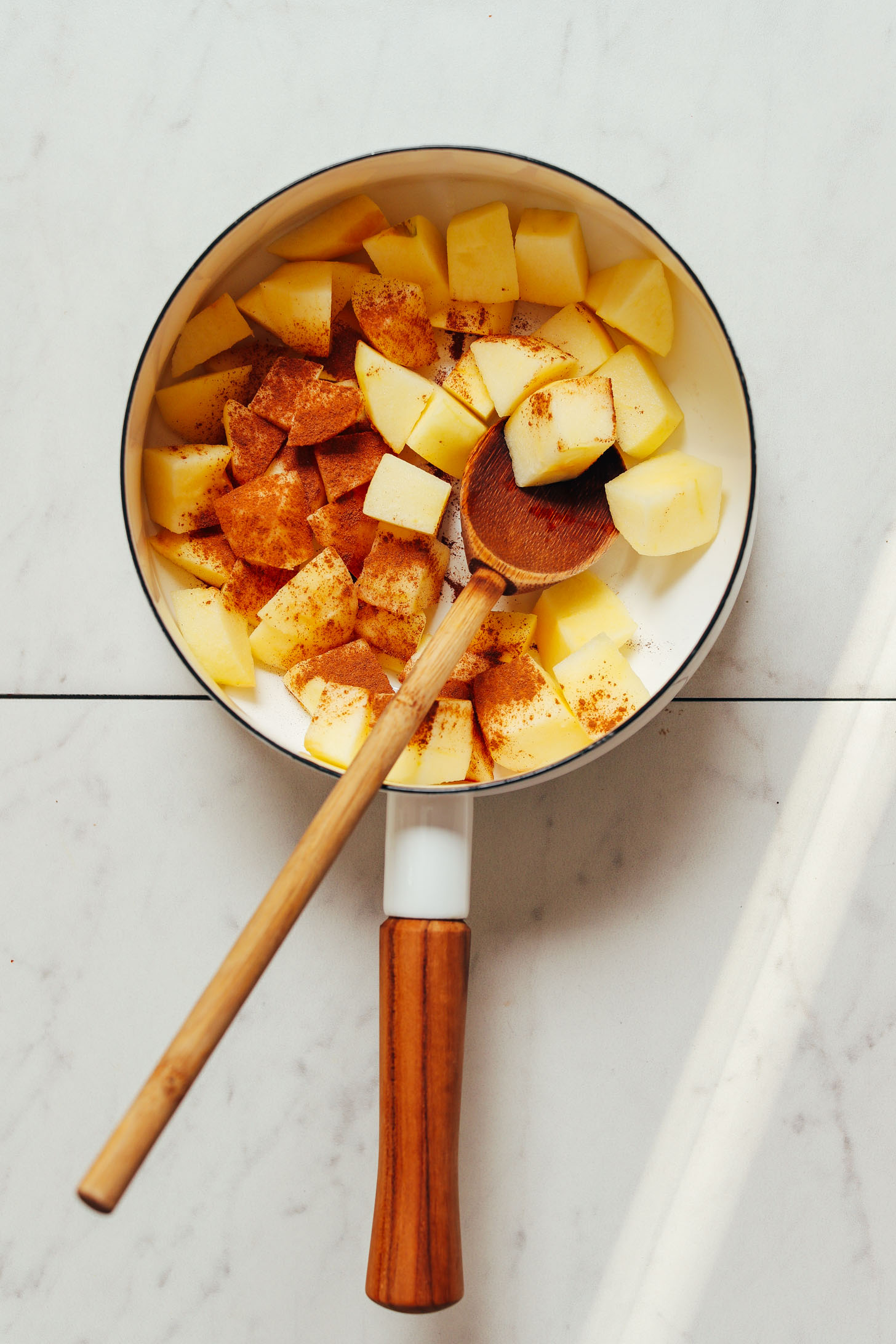 Diced apples and cinnamon in a saucepan for making our simple homemade applesauce recipe