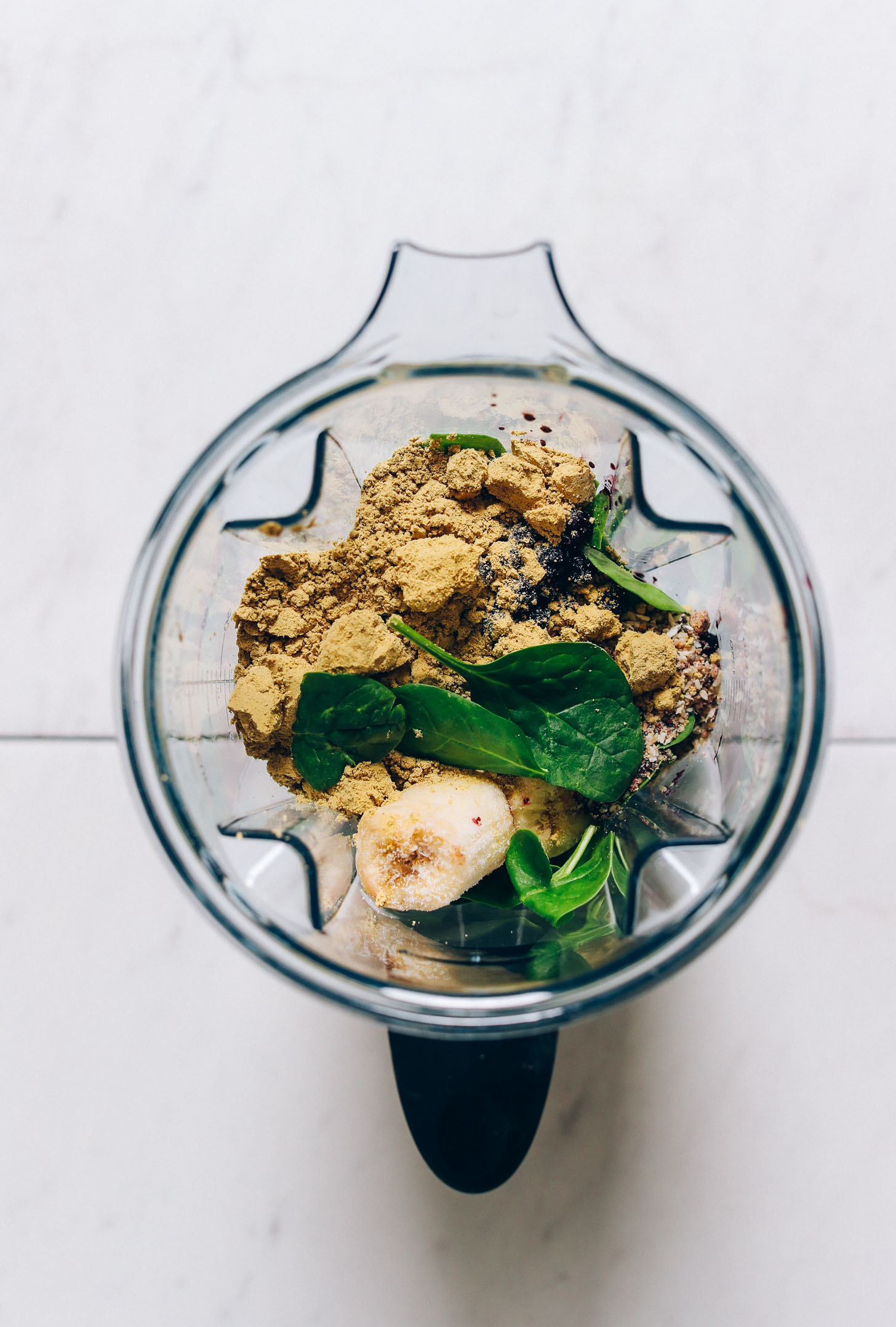 Blender filled with ingredients for making our Blueberry Peanut Butter Smoothie