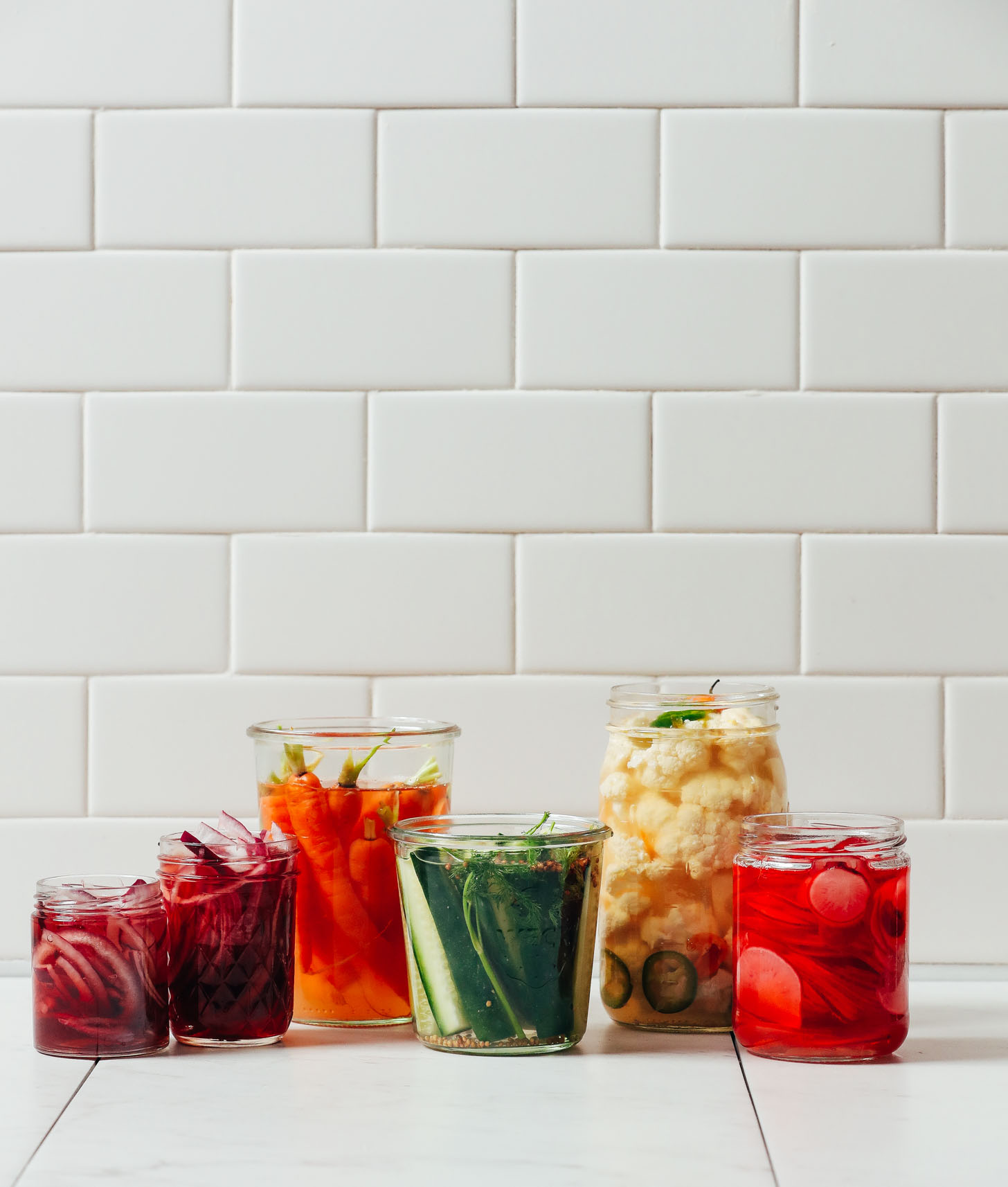 Jars of Quick Pickled Vegetables including onion, carrot, cucumber, cauliflower, and radish