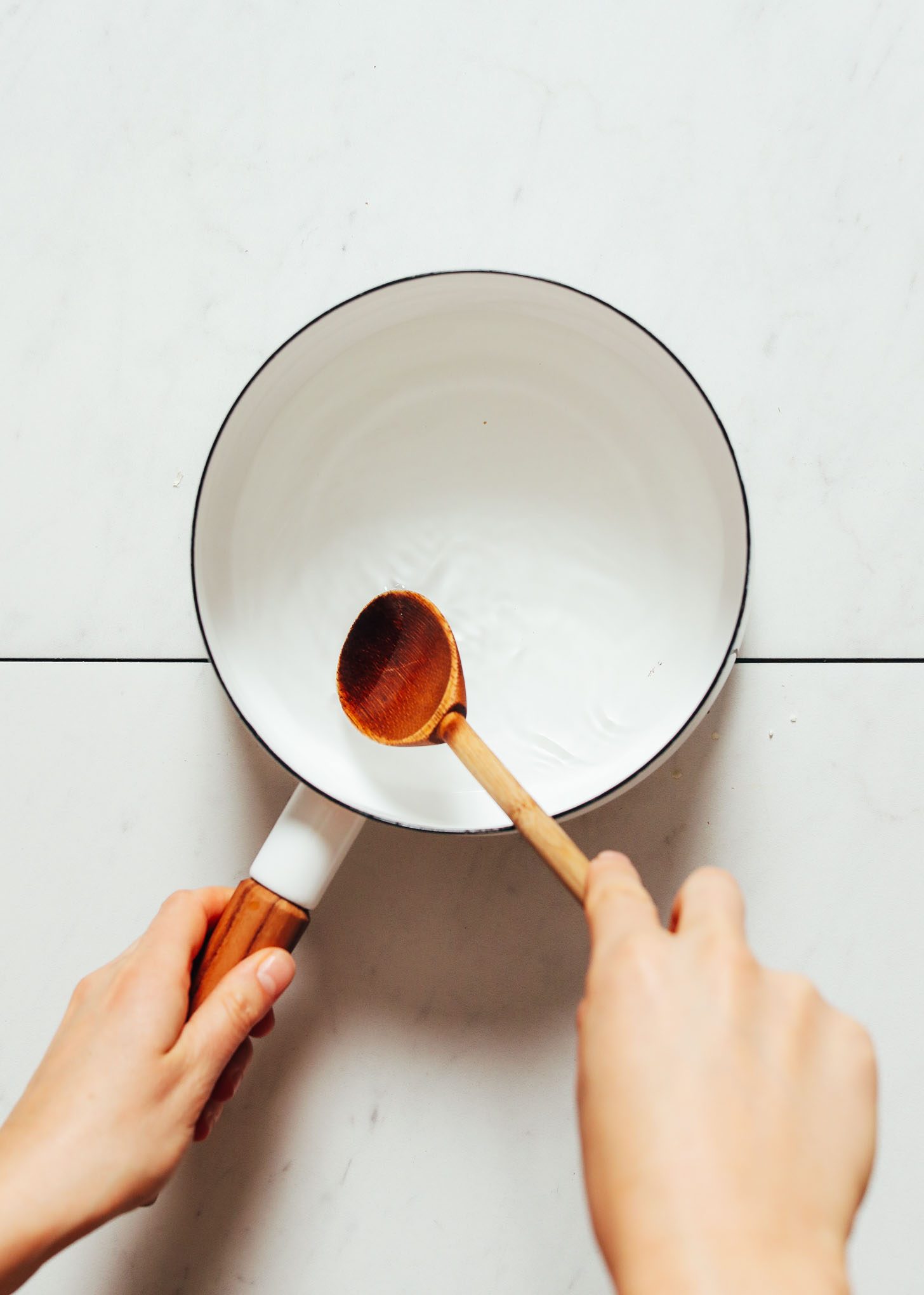 Stirring a pan of vinegar for making Quick Pickled Radishes