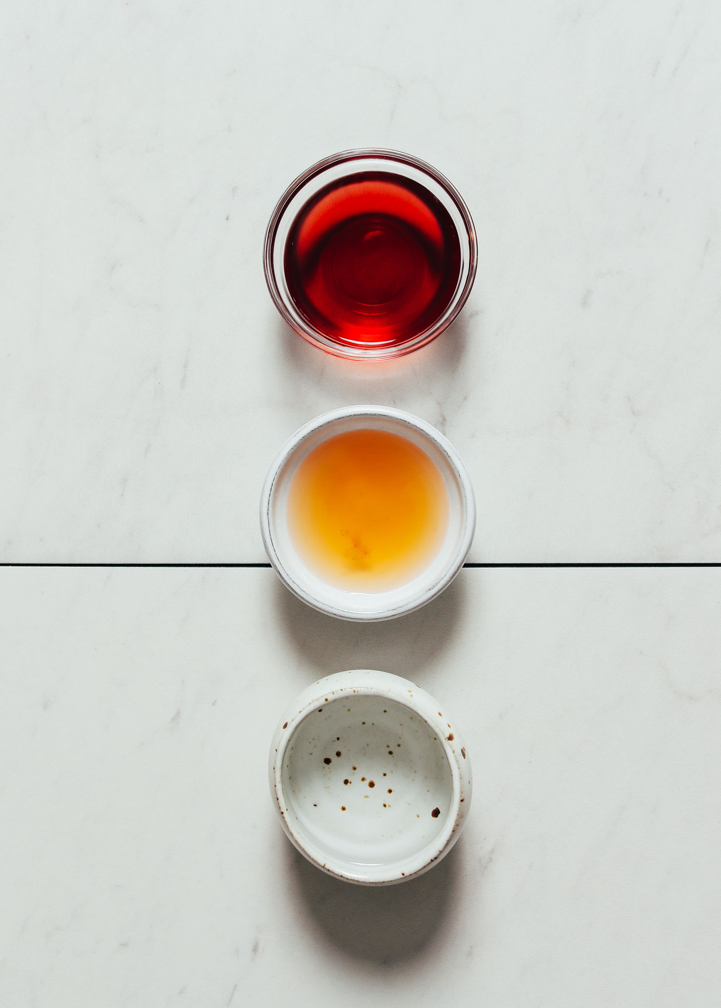 Three bowls of different types of vinegars for making Quick Pickled Vegetables