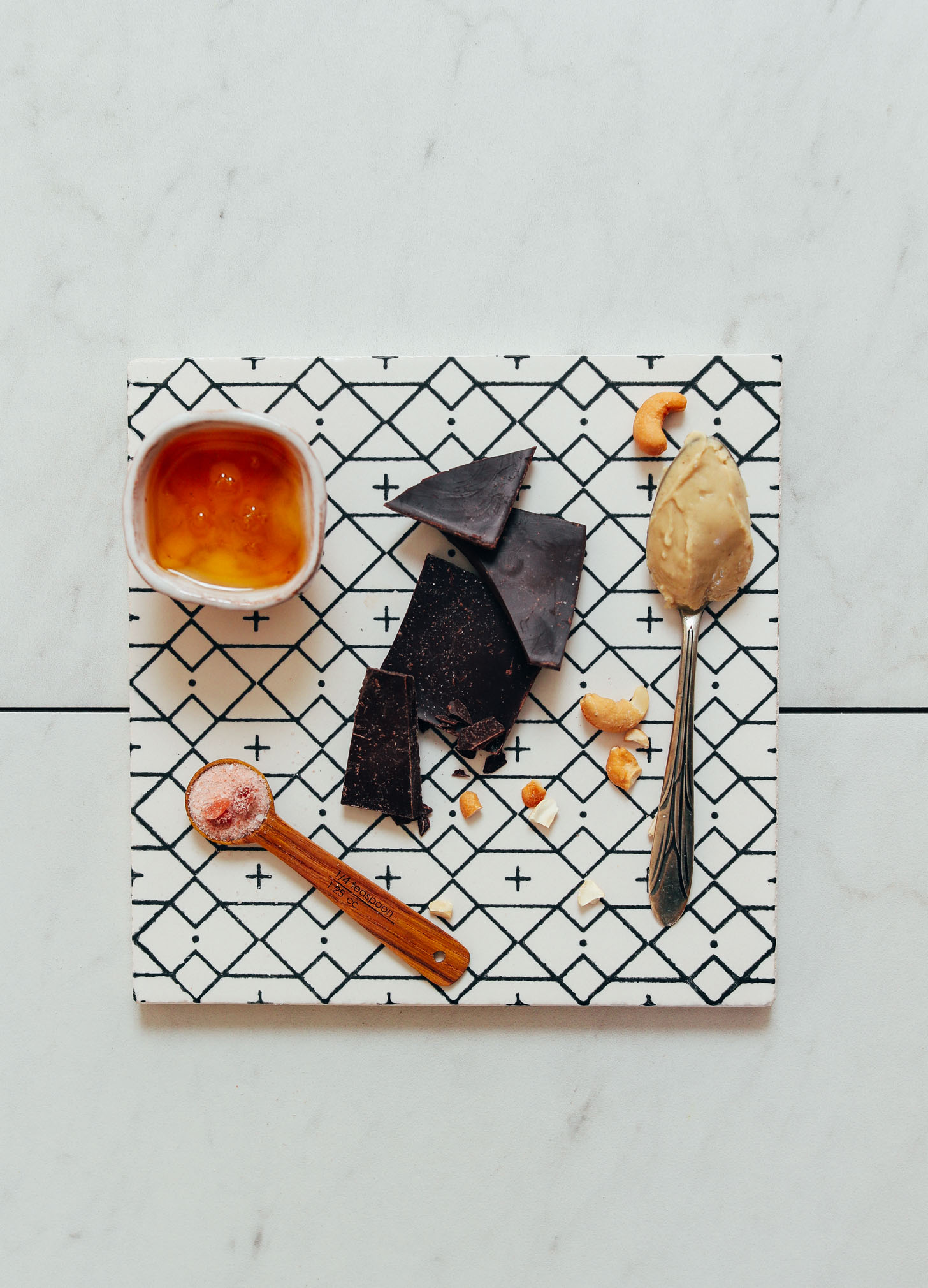 Honey, salt, dark chocolate, and cashew butter for making honey-sweetened Chocolate Fudge