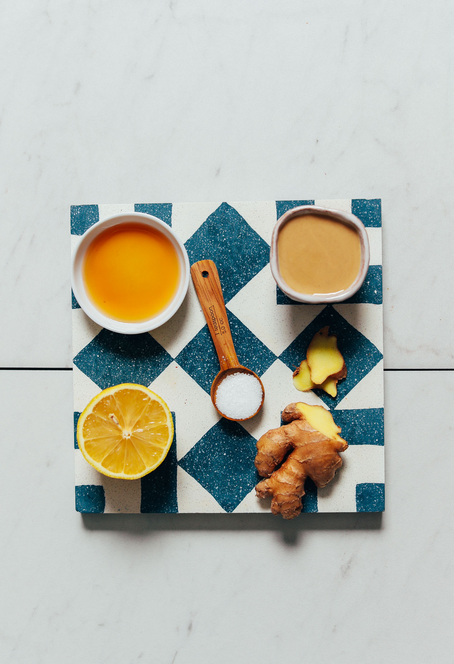 Maple syrup, tahini, lemon, salt, and ginger for making our easy Lemon Tahini Sauce recipe