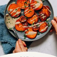 Plate of sweet potatoes drizzled with tahini with text saying 8-Minute Sweet Potatoes