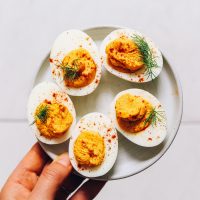 Plate of Mayo-Free Deviled Eggs seasoned with turmeric, honey, and other spices