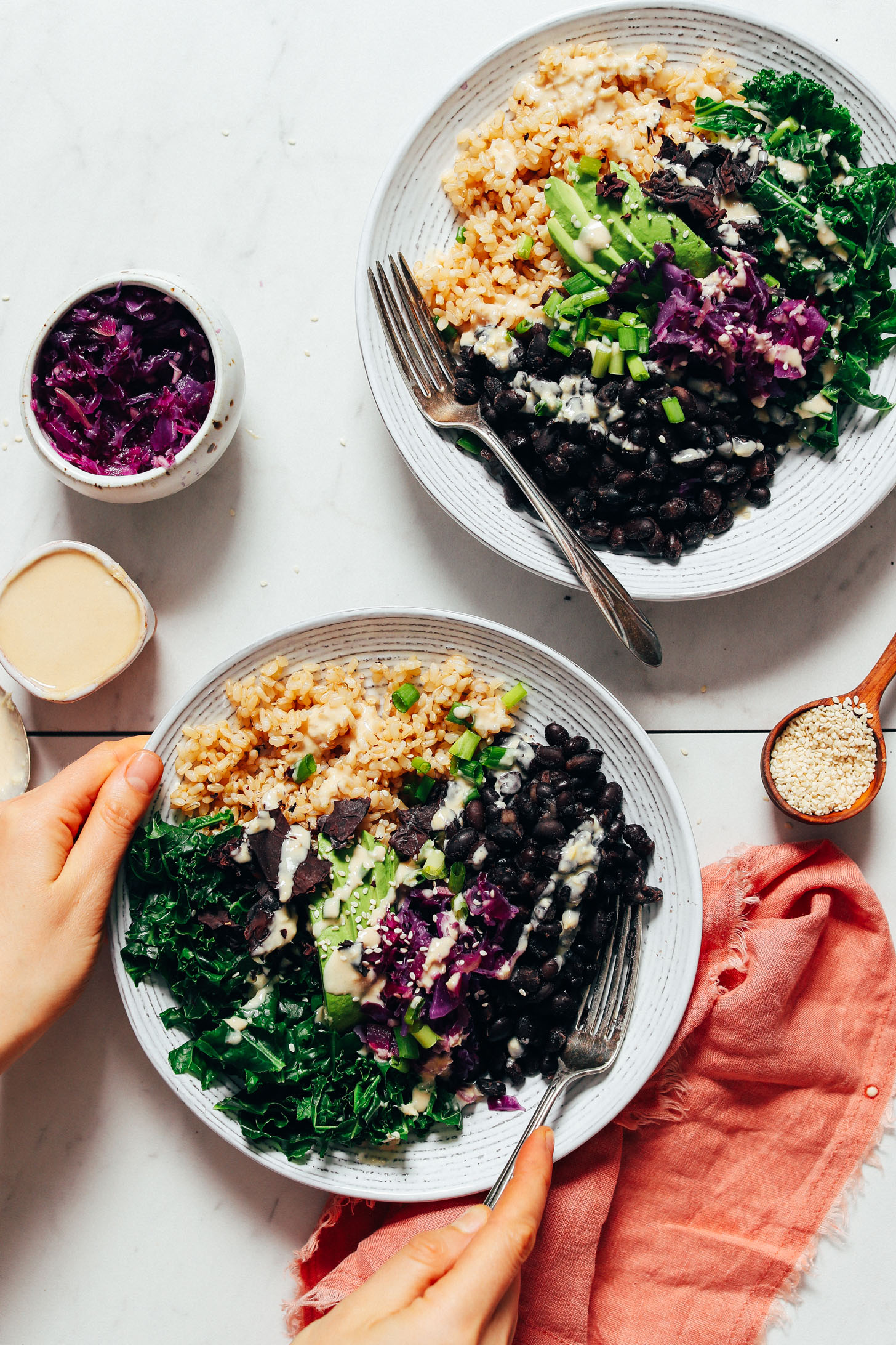 Holding the side of a Black Bean Buddha Bowl with Lemon Ginger Tahini Dressing