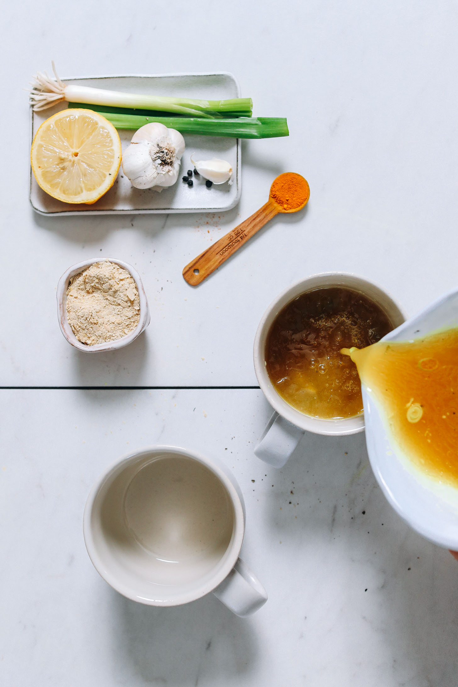 Pouring mugs of our Chicken Bone Broth Tonic