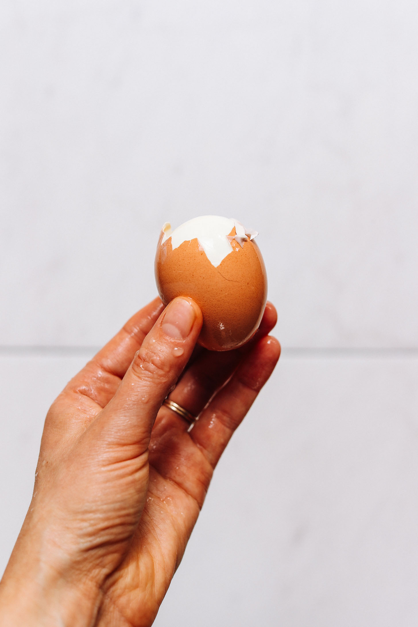 Showing a partially peeled hard boiled egg