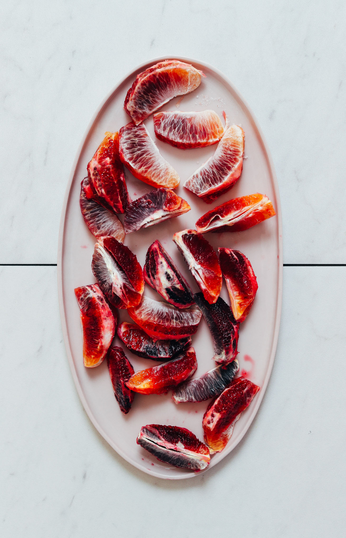 Platter of blood orange segments for freezing and making our Blood Orange Creamsicle Smoothie recipe