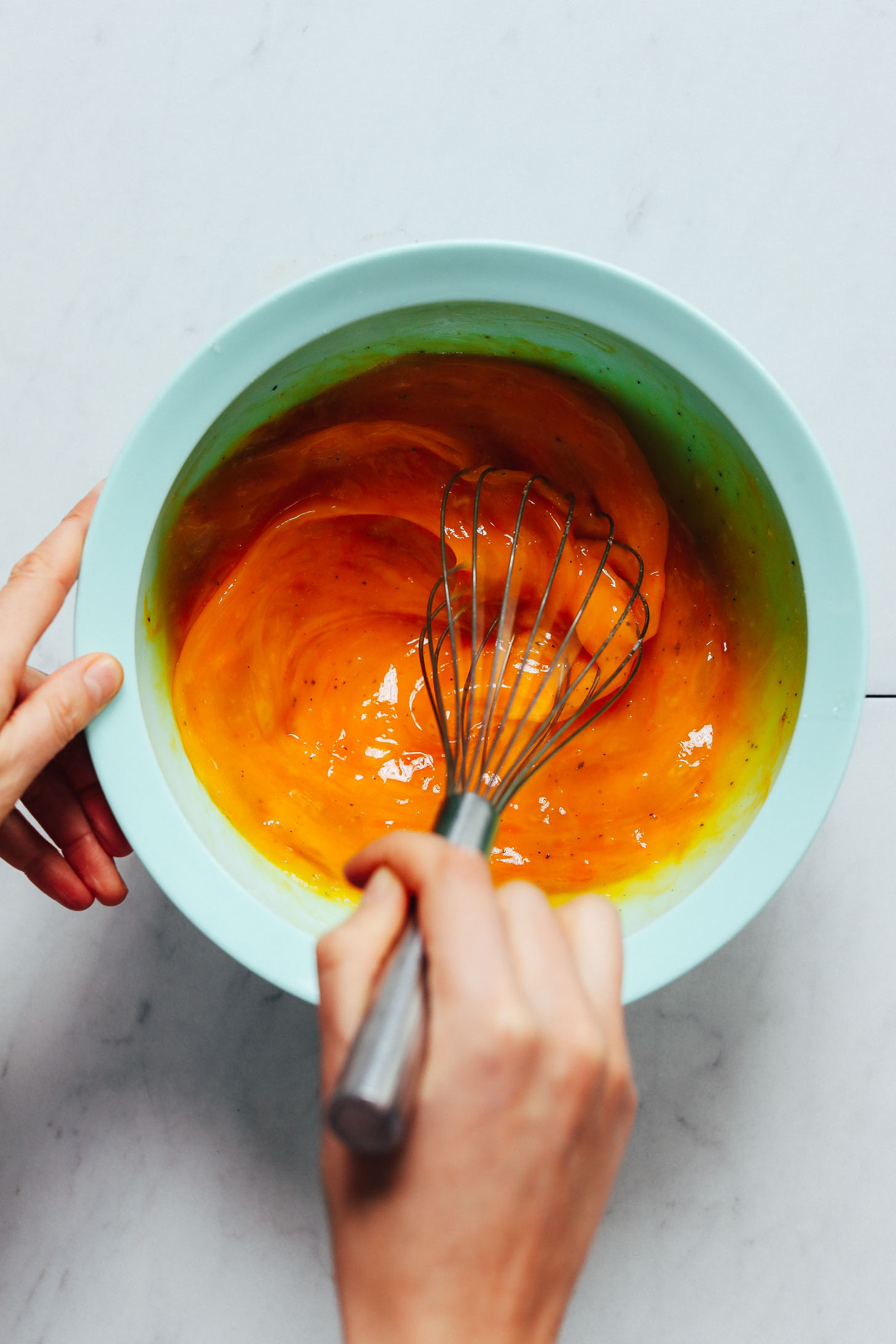 Whisking pasture-raised eggs with dairy-free milk for our Spring Frittata recipe