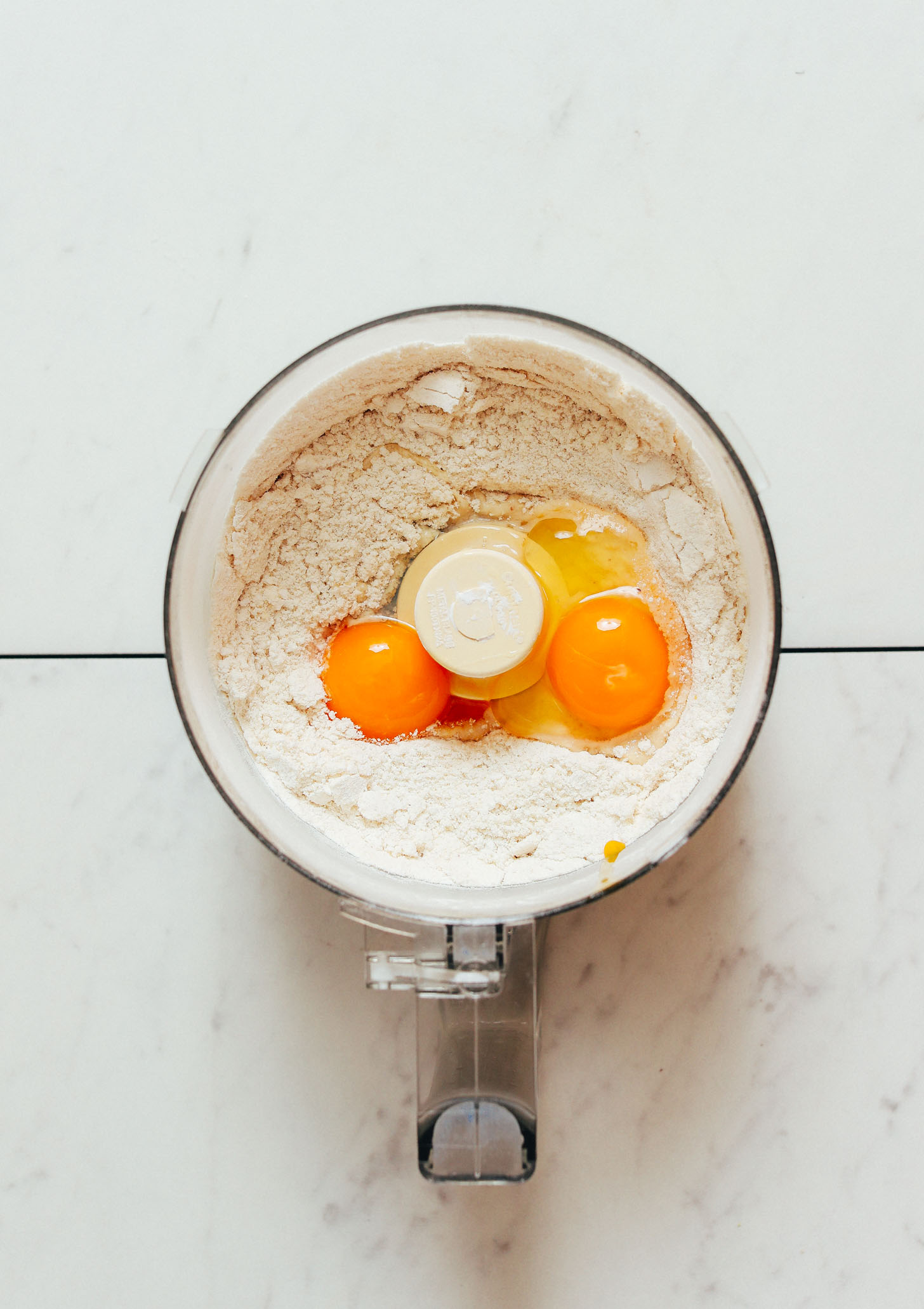 Food processor with gluten-free flours and eggs for making homemade pasta