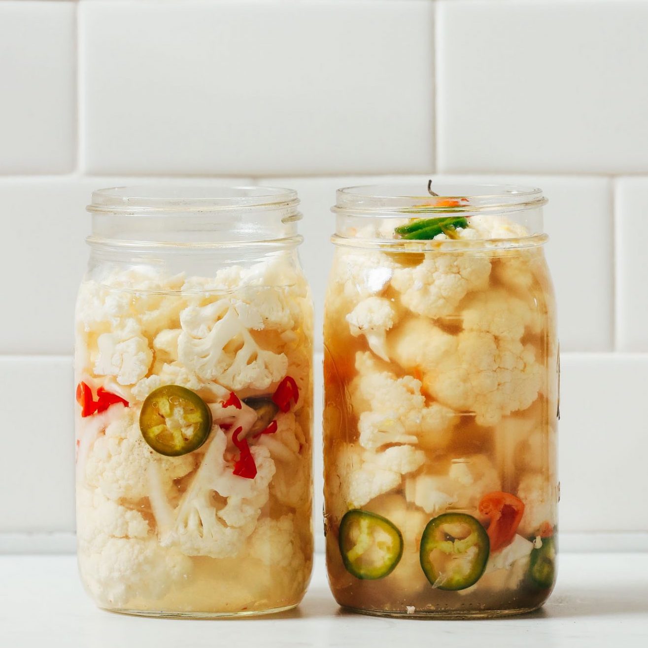 Two jars of Escabeche made with jalapeño and habanero