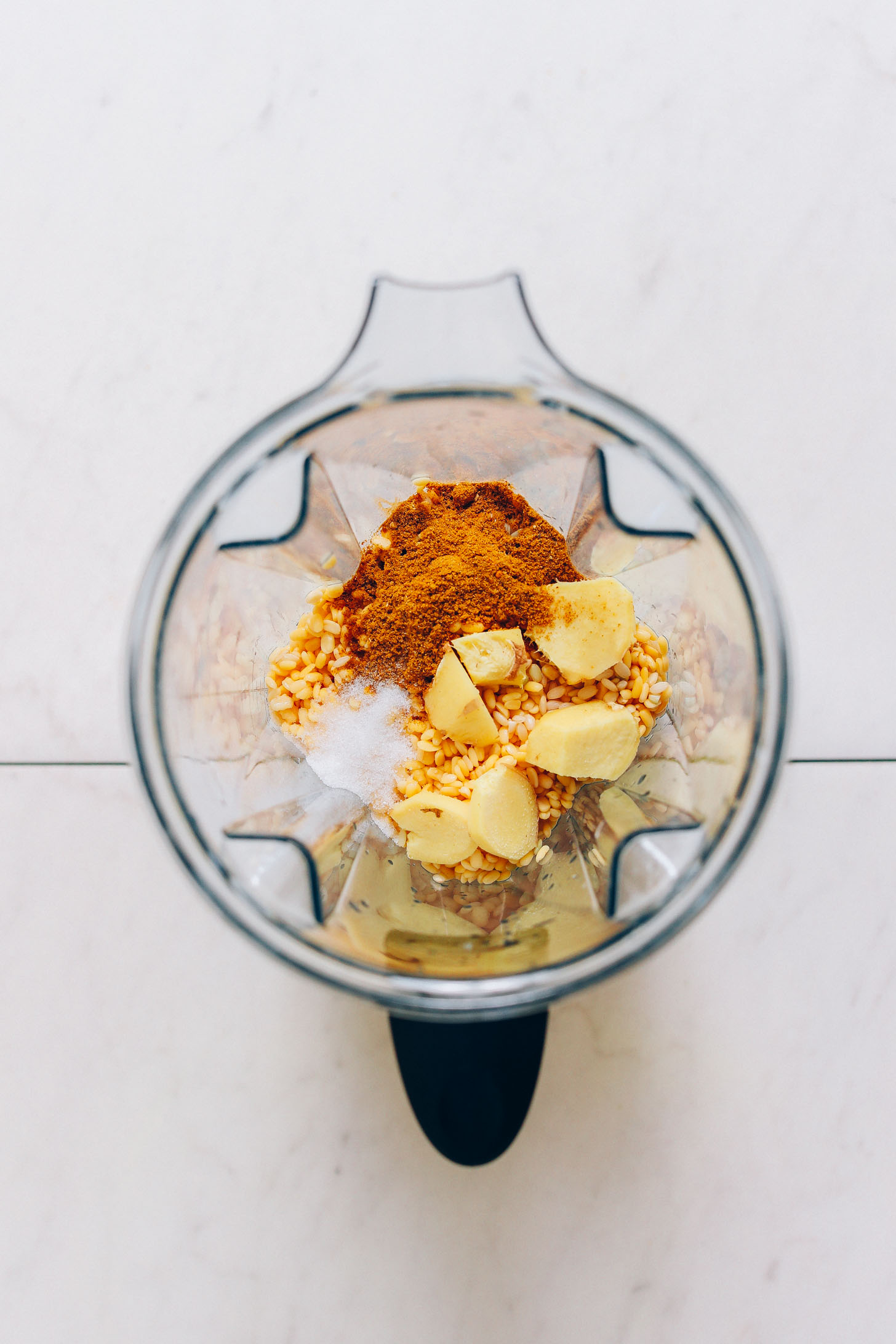 Soaked moong dal, brown rice, curry powder, ginger, and salt in a blender for making moong dal dosas