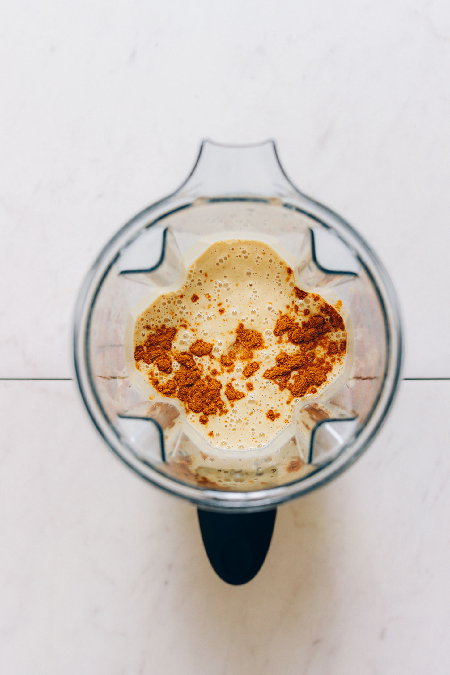 Blender filled with moong dal, curry powder, and other ingredients for making our dosa recipe