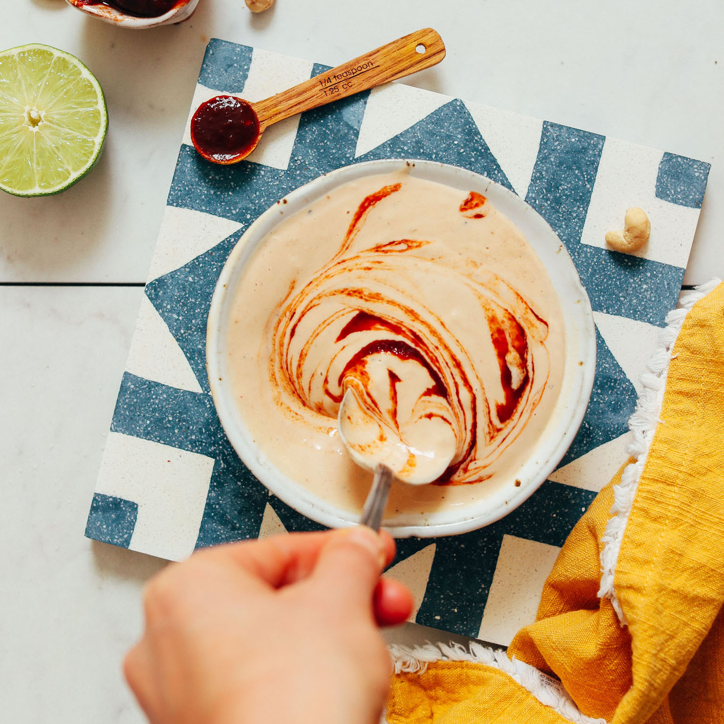Bowl of Creamy Vegan Chipotle Dressing topped with a swirl of adobo sauce