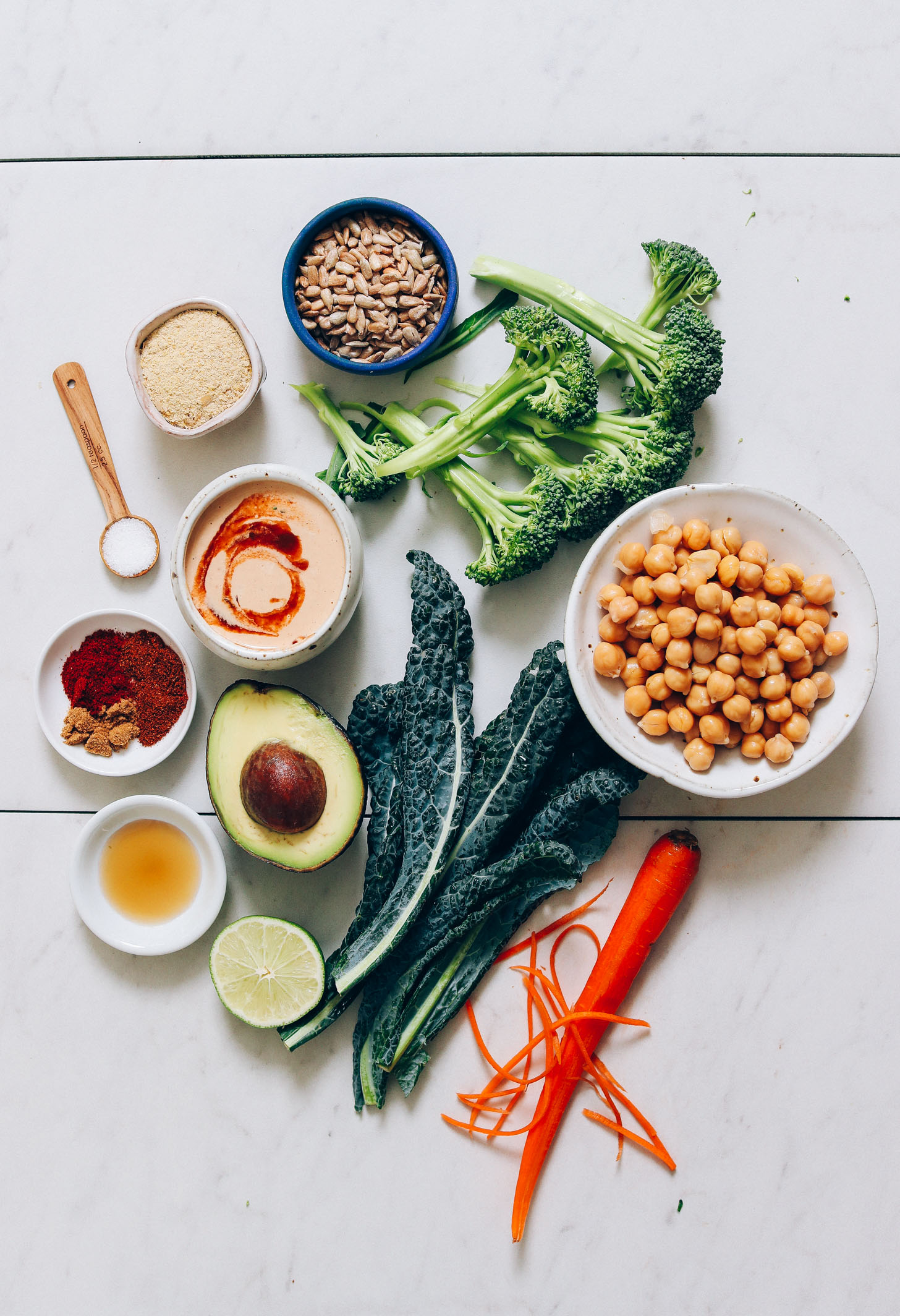 Kale, carrots, avocado, chickpeas, broccoli, sunflower seeds, spices, nutritional yeast, maple syrup, and chipotle dressing