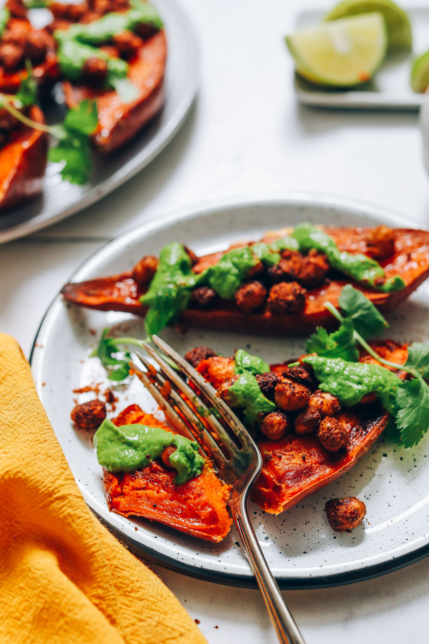 Fork cutting into a bite of Chickpea Stuffed Sweet Potatoes