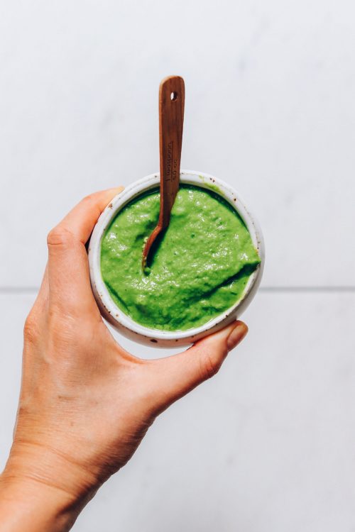Holding a bowl of homemade green chutney