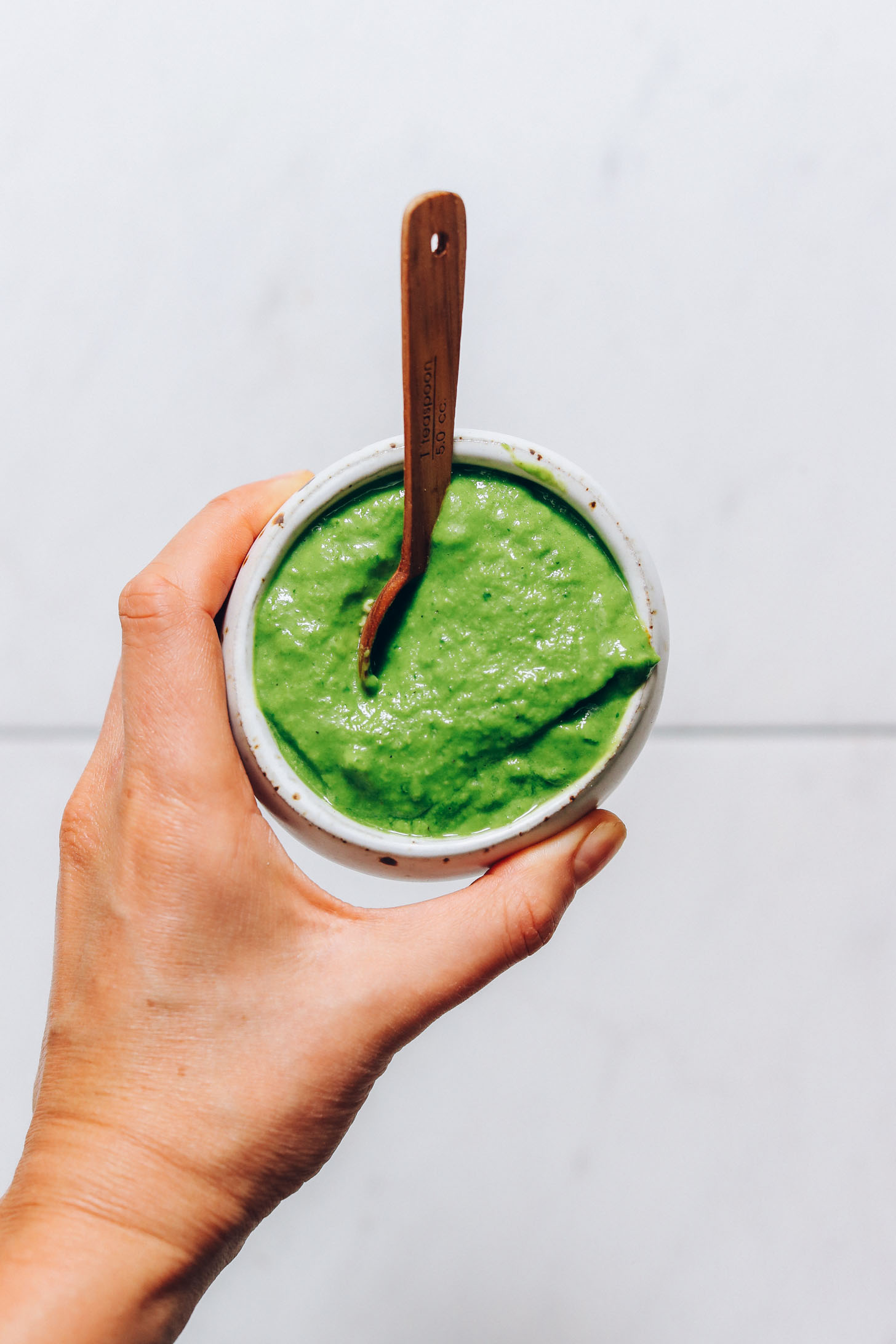 Holding a bowl of green chutney