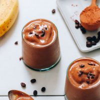 Glasses of our Cold Brew Smoothie recipe beside ingredients used to make it