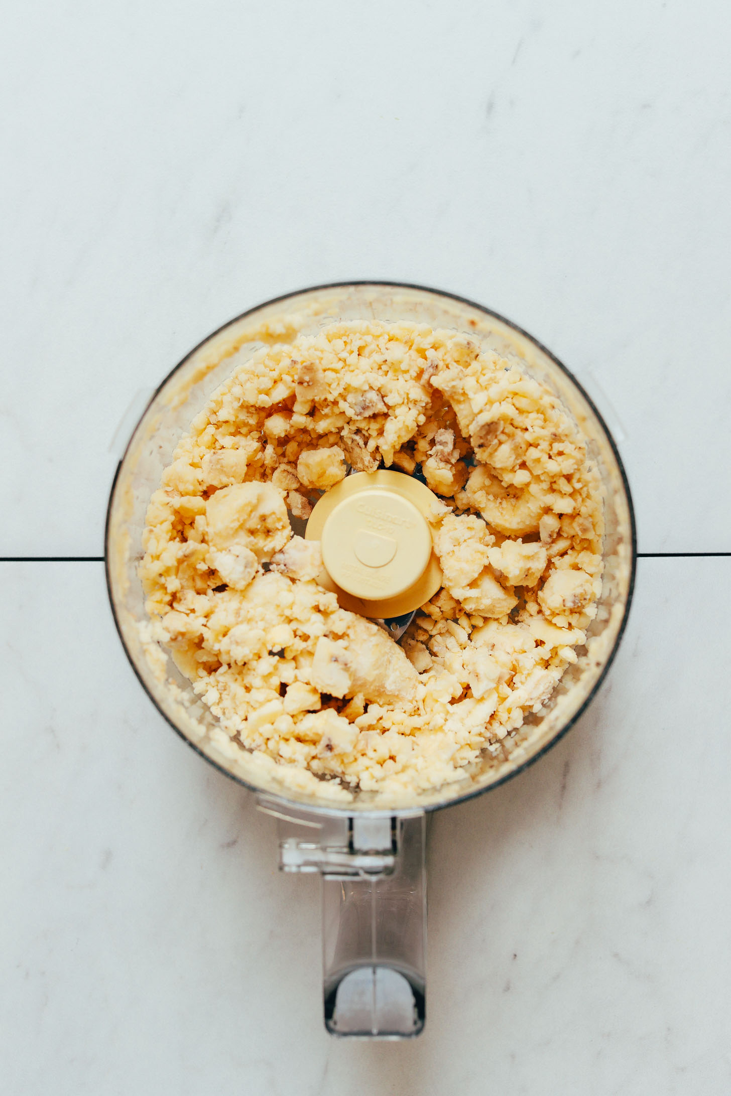 Partially chopped frozen bananas for making Banana Nice Cream in a food processor