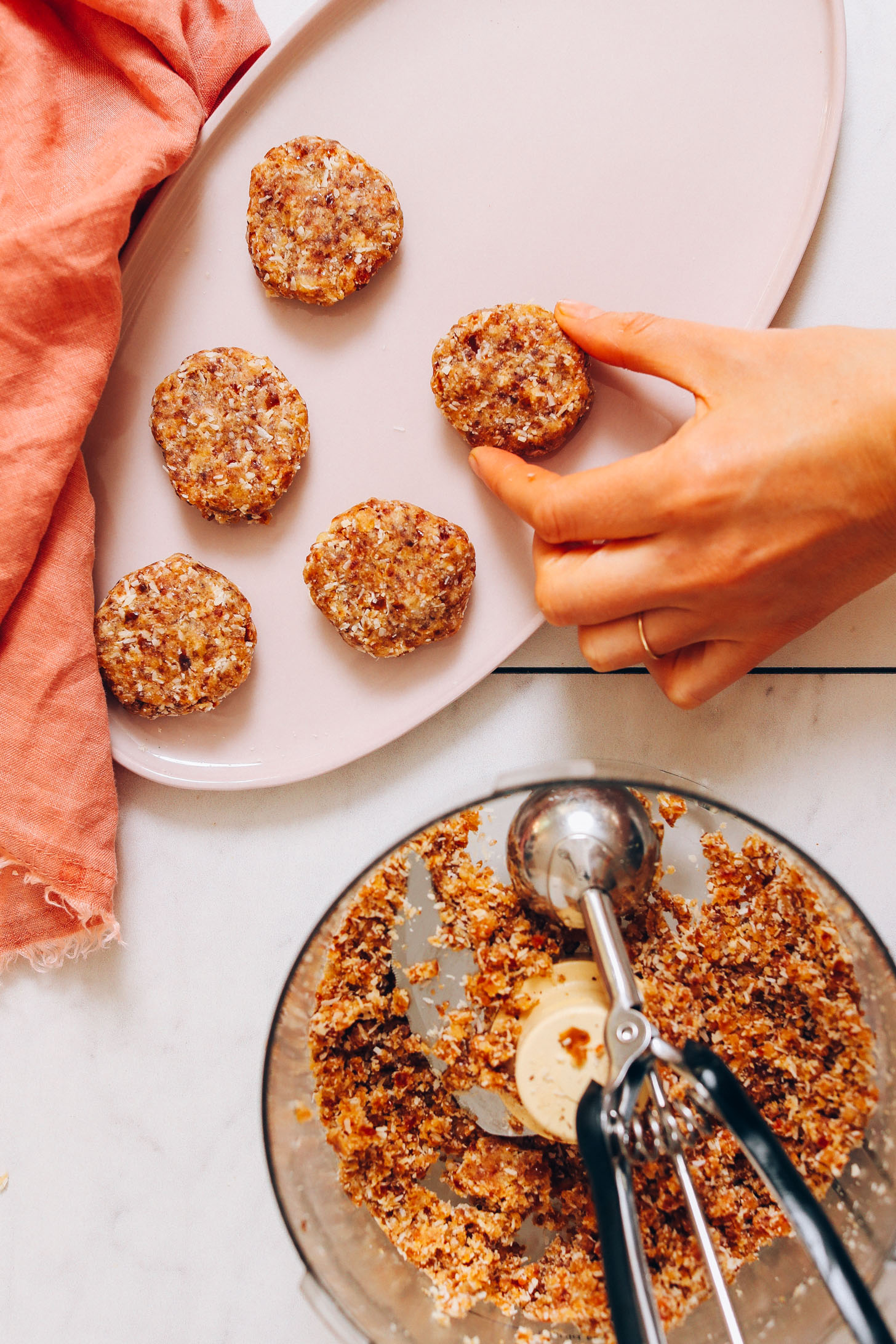 Placing cookie dough from the food processor onto a platter