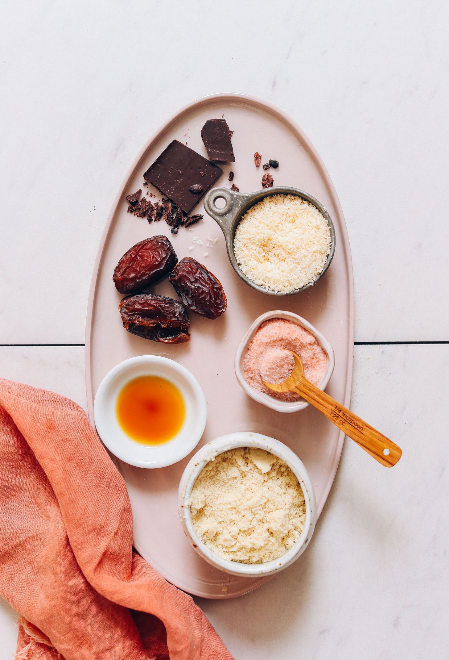 Platter with dark chocolate, dates, coconut, vanilla, salt, and almond flour