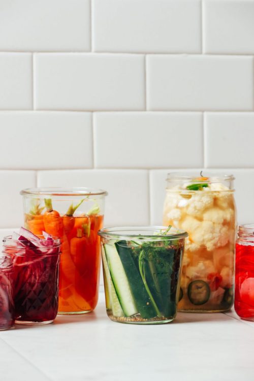 Jars of Quick Pickled Vegetables including, cucumbers, carrots, radishes, cauliflower, and onions