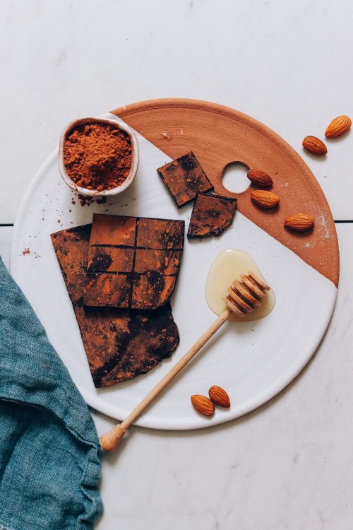 Homemade Honey-Sweetened Chocolate Bars beside ingredients used to make them