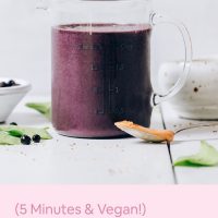 Blueberry Peanut Butter Smoothie in liquid measuring cup shown with ingredients and recipe title