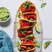 Platter of Spicy Baked Fish Tacos with limes and guacamole